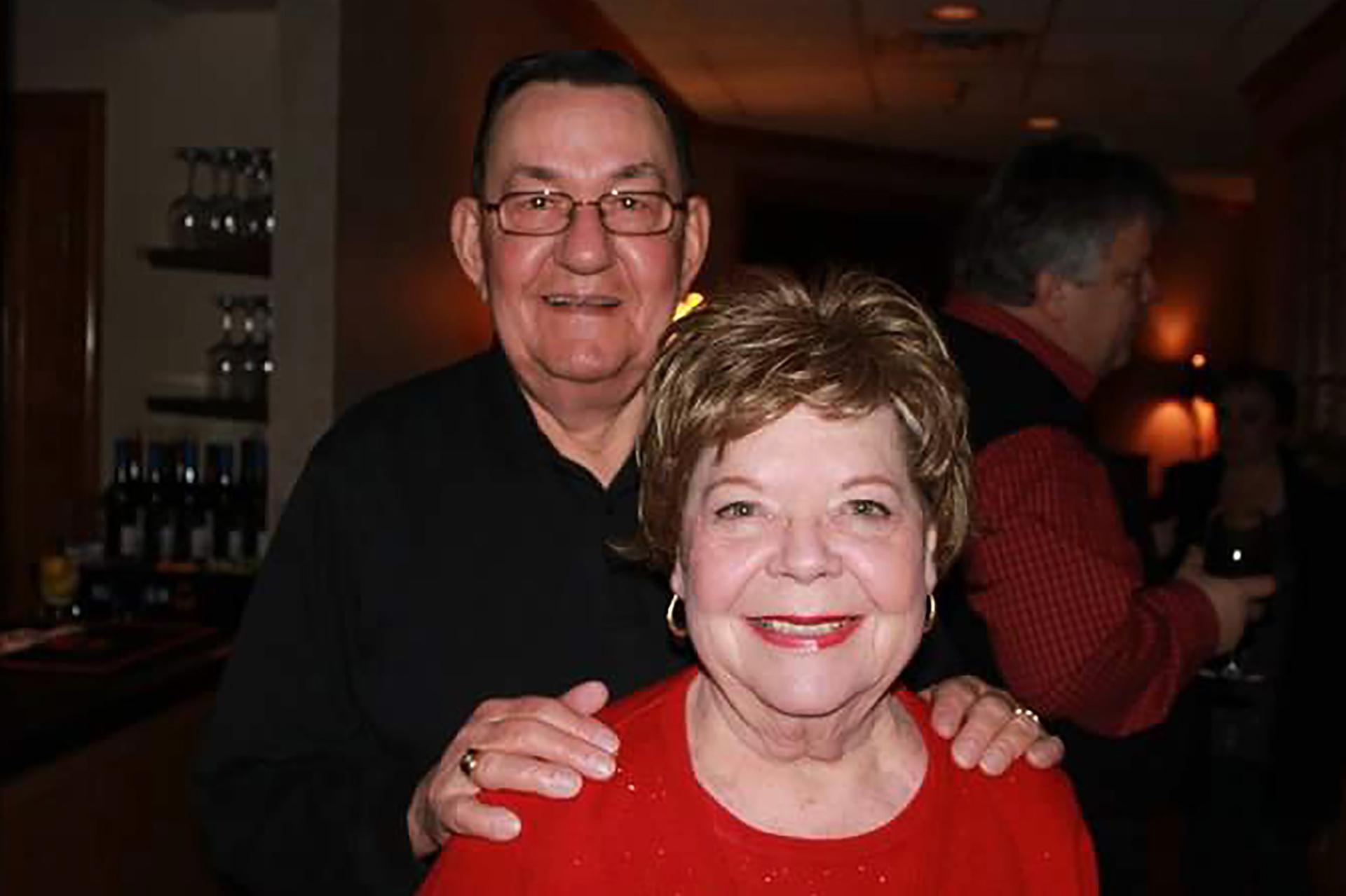 In this 2011 family photo provided by Dawn Bouska, Charles Recka and his wife, Patricia Recka, pose for a photo at a banquet in Naperville, Illinois. Charles Recka died on March 12, 2020. (Courtesy of Dawn Bouska via AP)