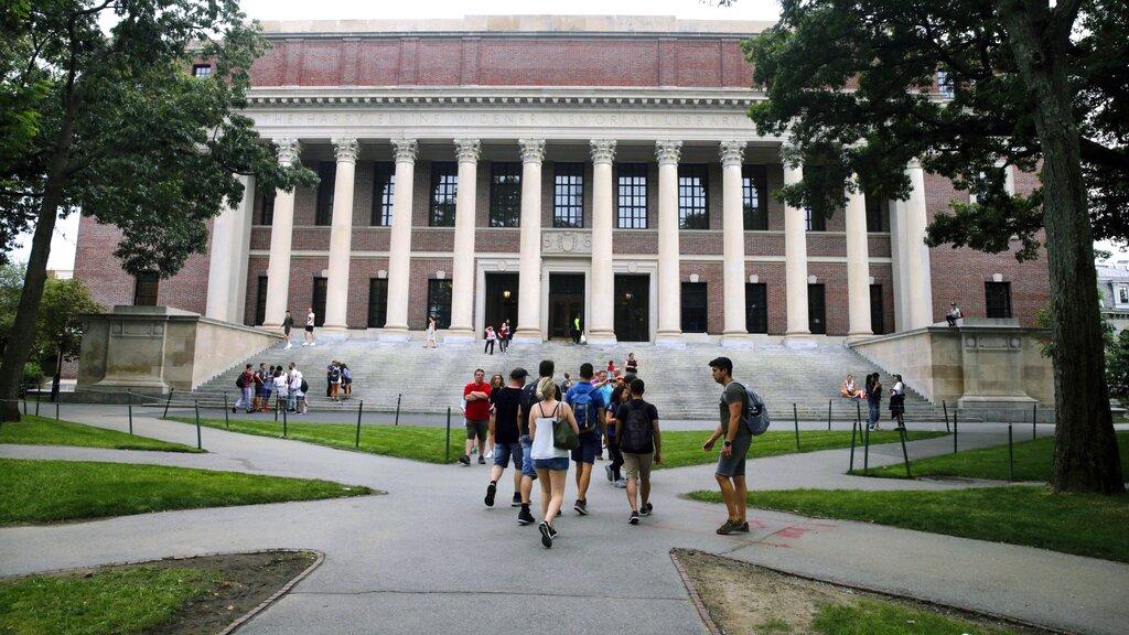 In this Aug. 13, 2019 file photo, students walk near the Widener Library in Harvard Yard at Harvard University in Cambridge, Mass. (AP Photo / Charles Krupa, File)