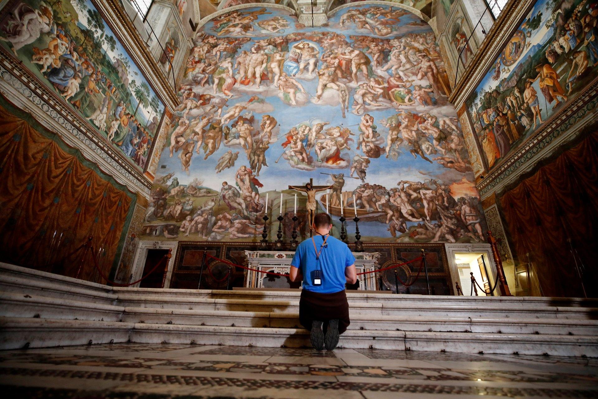 A visitor kneels in front of the Last Judgement fresco by the Italian Renaissance painter Michelangelo inside the Sistine Chapel of the Vatican Museums on the occasion of the museum's reopening, in Rome, Monday, May 3, 2021. The Vatican Museums reopened Monday to visitors after a shutdown following COVID-19 containment measures. (AP Photo / Alessandra Tarantino)