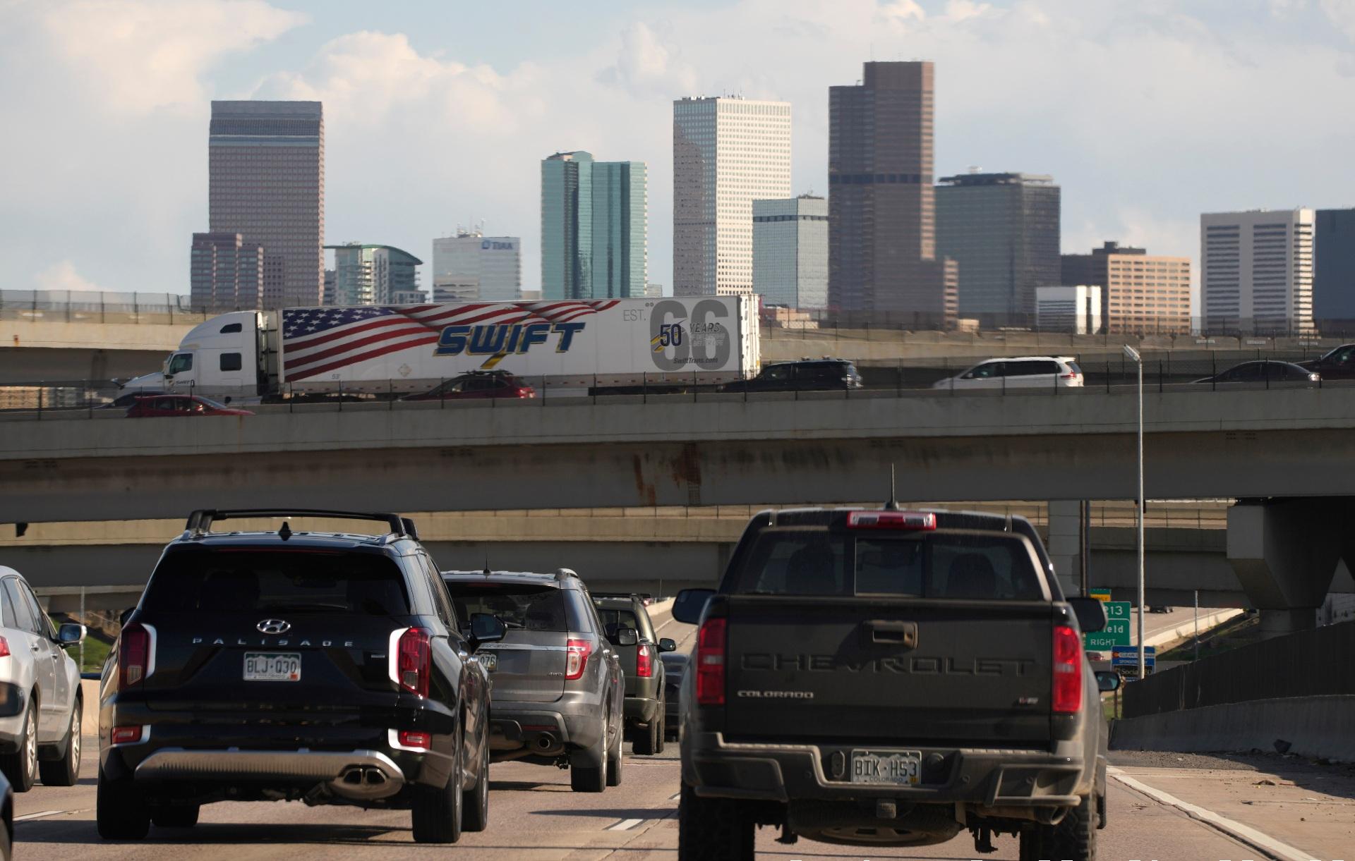 In this May 27, 2021 file photo, vehicles move along southbound Interstate 25 while motorists sit on the Interstate 70 overpass to start the Memorial Day weekend in Denver. (AP Photo / David Zalubowski)