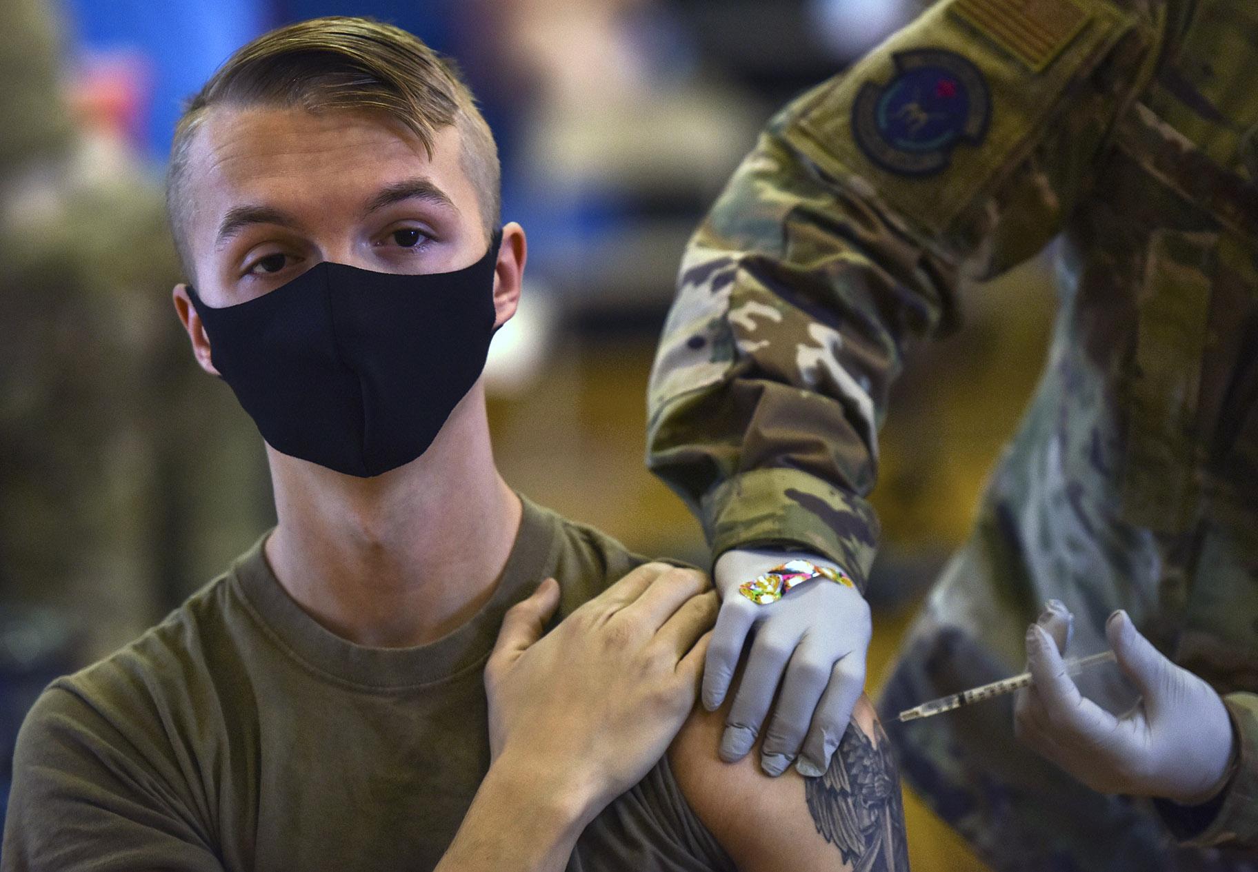In this Feb. 9, 2021, file photo provided by the Department of Defense, Hickam 15th Medical Group hosts the first COVID-19 mass vaccination on Joint Base Pearl Harbor-Hickam. (U.S. Air Force Tech. Sgt. Anthony Nelson Jr. / Department of Defense via AP)