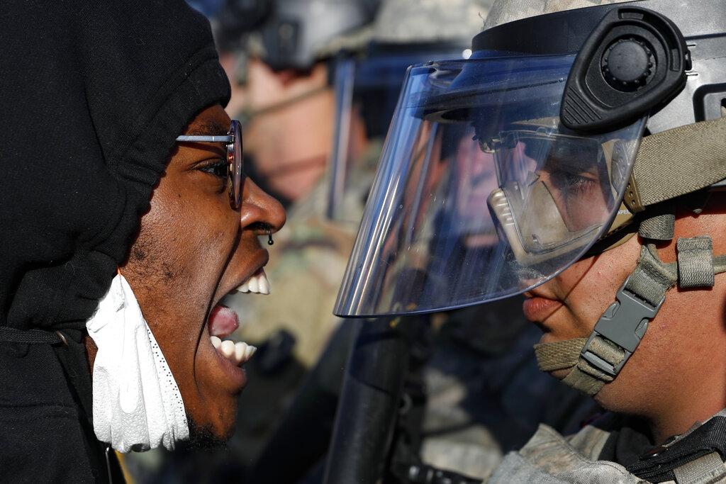 Protesters and National Guardsmen face off on East Lake Street, Friday, May 29, 2020, in St. Paul, Minn. (AP Photo / John Minchillo)