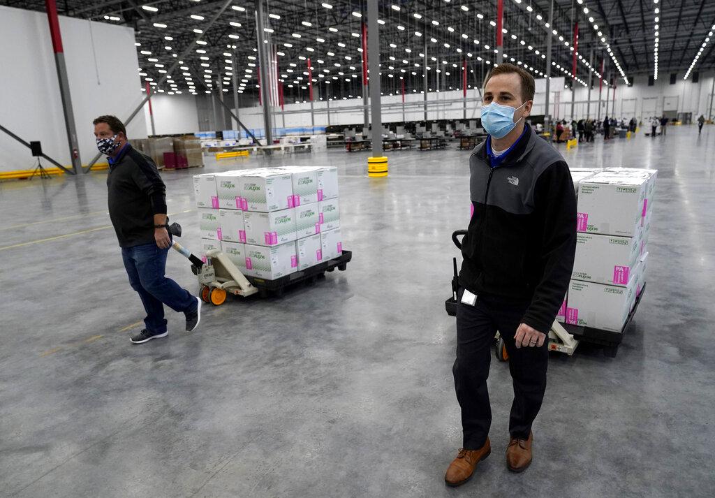 Boxes containing the Moderna COVID-19 vaccine are moved to the loading dock for shipping at the McKesson distribution center in Olive Branch, Miss., Sunday, Dec. 20, 2020. (AP Photo / Paul Sancya, Pool)