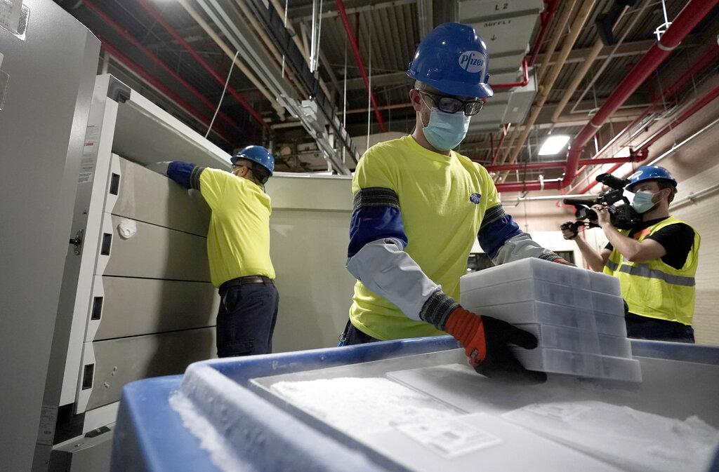 Boxes containing the Pfizer-BioNTech COVID-19 vaccine are prepared to be shipped at the Pfizer Global Supply Kalamazoo manufacturing plant in Portage, Mich., Sunday, Dec. 13, 2020. (AP Photo / Morry Gash, Pool)
