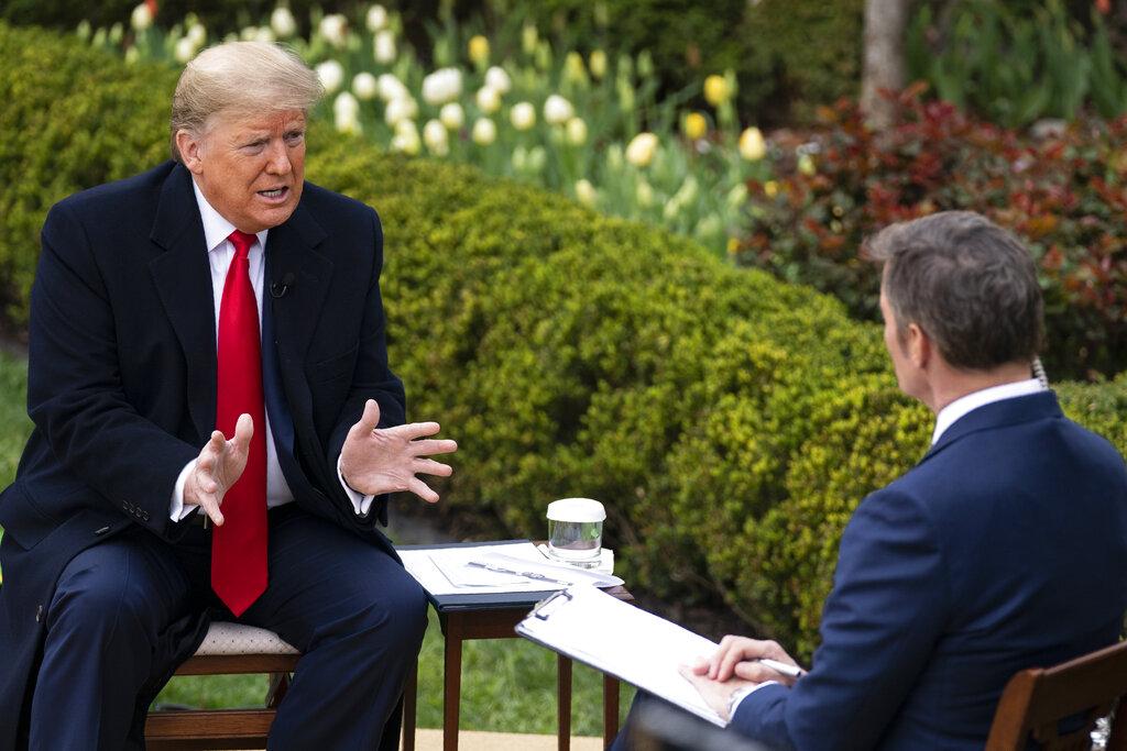 President Donald Trump talks with host Bill Hemmer during a Fox News virtual town hall with members of the coronavirus task force, in the Rose Garden at the White House, Tuesday, March 24, 2020, in Washington. (AP Photo / Evan Vucci)