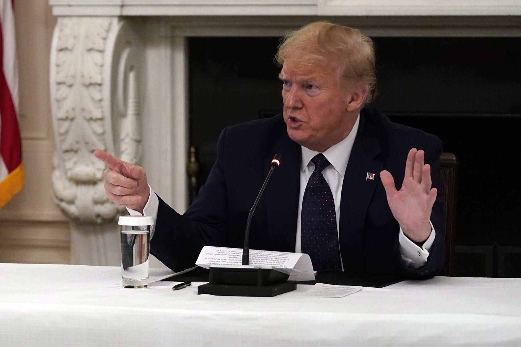 President Donald Trump tells reporters that he is taking zinc and hydroxychloroquine during a meeting with restaurant industry executives about the coronavirus response, in the State Dining Room of the White House, Monday, May 18, 2020, in Washington. (AP Photo / Evan Vucci)