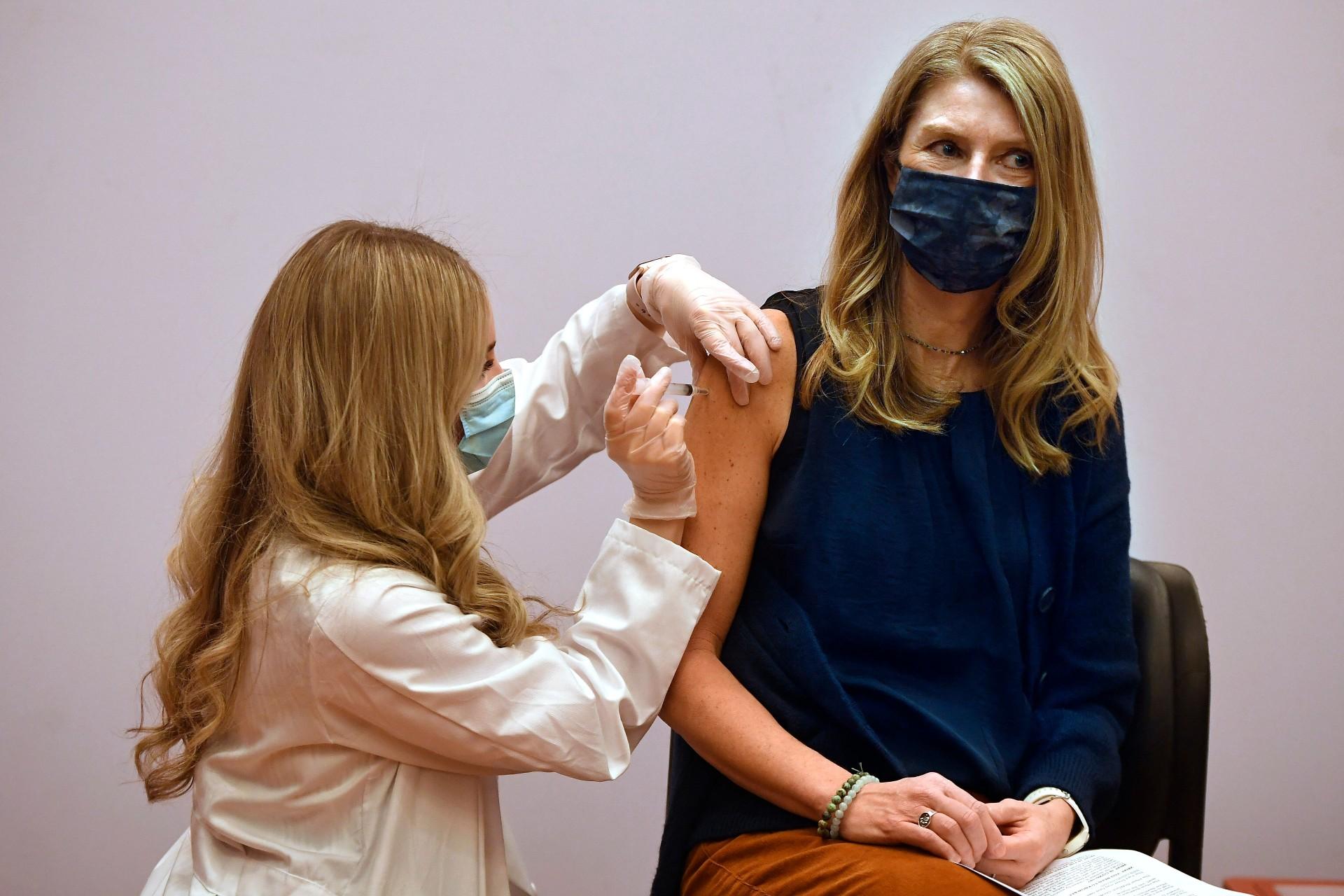 Granby kindergarten school teacher Christina Kibby receives the Johnson & Johnson COVID-19 vaccine by pharmacist Madeline Acquilano, left, at Hartford Hospital in Hartford, Conn., Wednesday, March 3, 2021.(AP Photo / Jessica Hill)