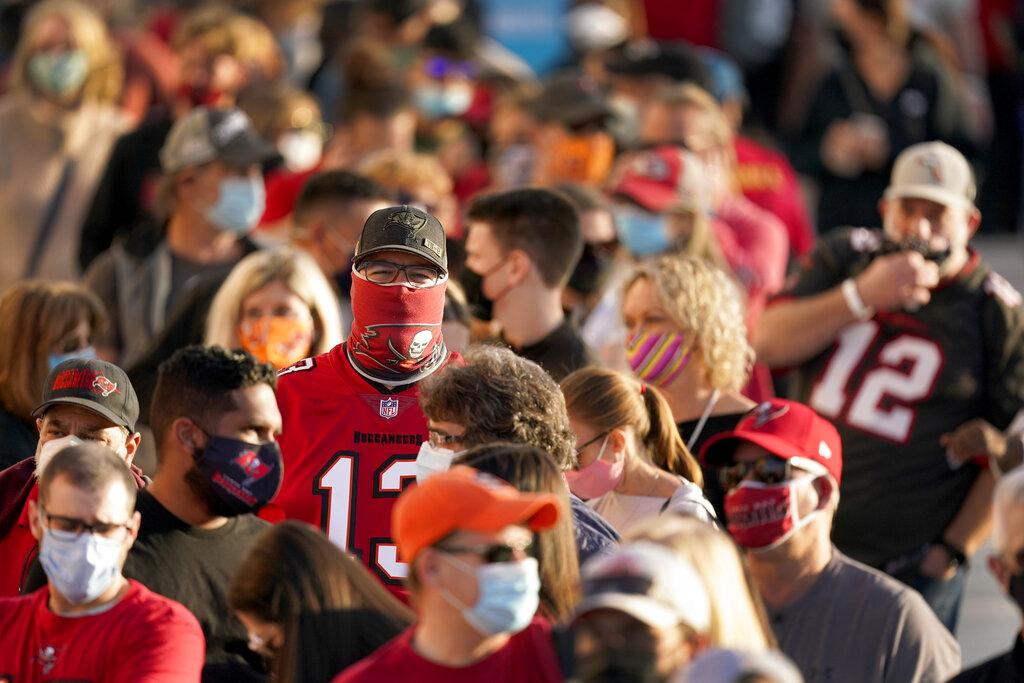 In this Feb. 4, 2021, file photo, people wait in line for an exhibit at the NFL Experience in Tampa, Fla. (AP Photo / Charlie Riedel, File)