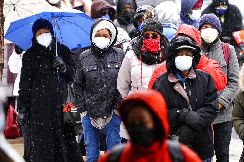 In this Feb. 19, 2021, file photo, people wait in line at a 24-hour, walk-up COVID-19 vaccination clinic hosted by the Black Doctors COVID-19 Consortium at Temple University’s Liacouras Center in Philadelphia. (AP Photo / Matt Rourke, File)