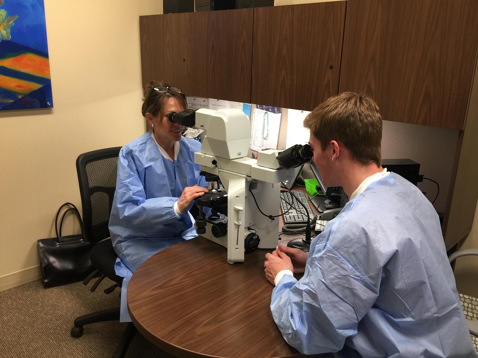 Pathologist Dr. Wendy Ward, left, and Zack Whitaker in the laboratory at Northwestern Medicine Huntley Hospital. (Courtesy of Northwestern Medicine)