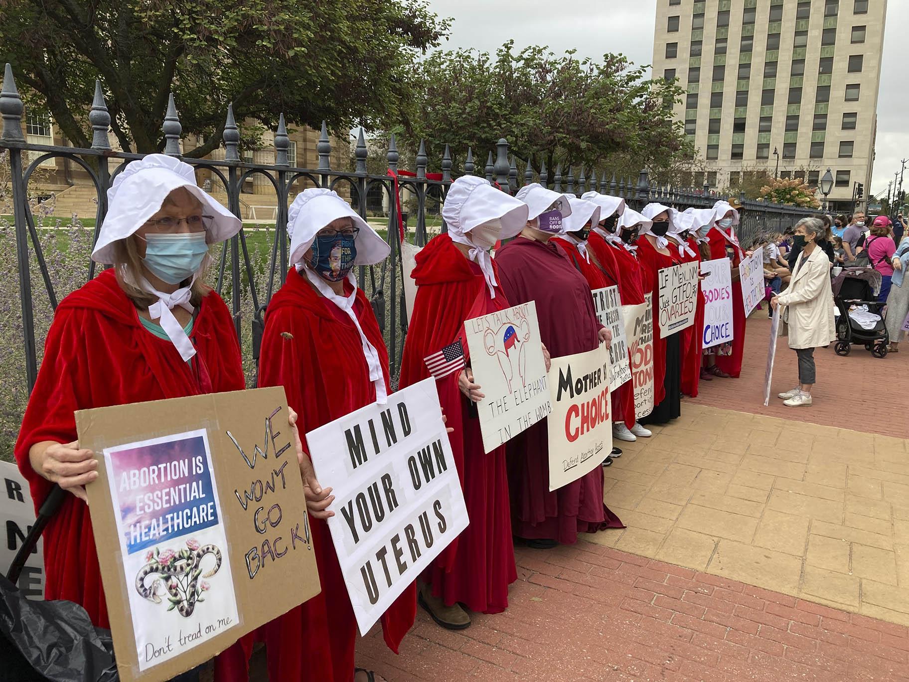 The Illinois Handmaids protest abortion restrictions at a rally in downtown Springfield, Ill., on Saturday, Oct. 2, 2021. (AP Photo / John O’Connor)
