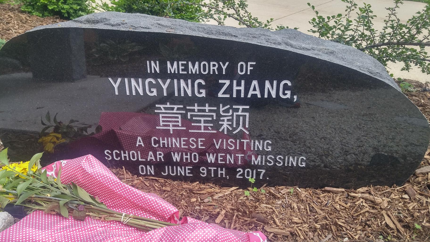 A memorial stone engraved with Yingying Zhang’s name in both English and Chinese is adorned with flowers on the campus of the University of Illinois at Urbana-Champaign on Friday, June 7, 2019. Zhang was last seen alive at a nearby bus stop on Friday, June 9, 2017. (Photo by Mark Van Moer)