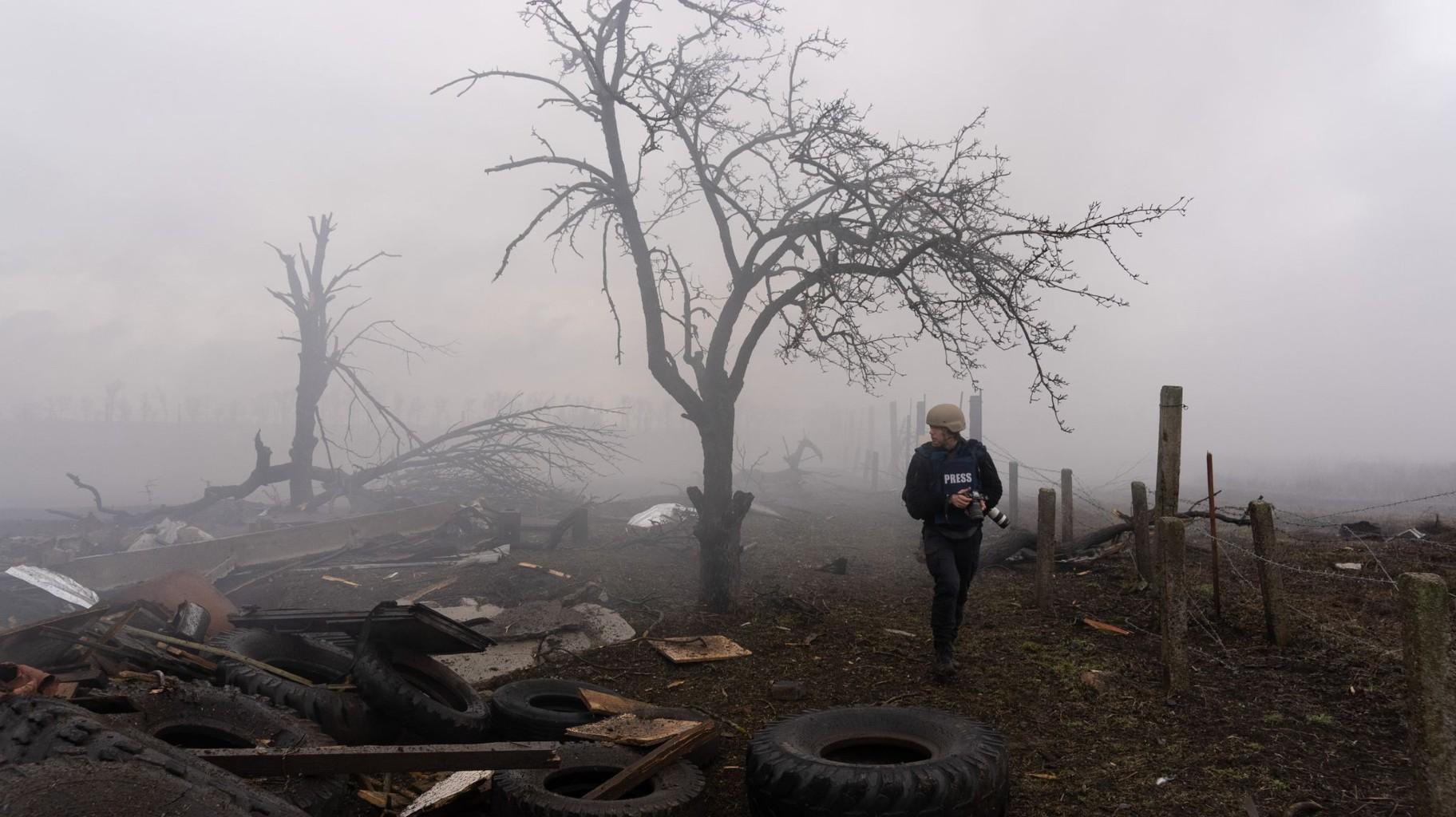 Photographer Evgeniy Maloletka picks his way through the aftermath of a Russian attack in Mariupol, Ukraine, Feb. 24, 2022. Still from FRONTLINE PBS and AP’s feature film “20 Days in Mariupol." (AP Photo / Mstyslav Chernov)
