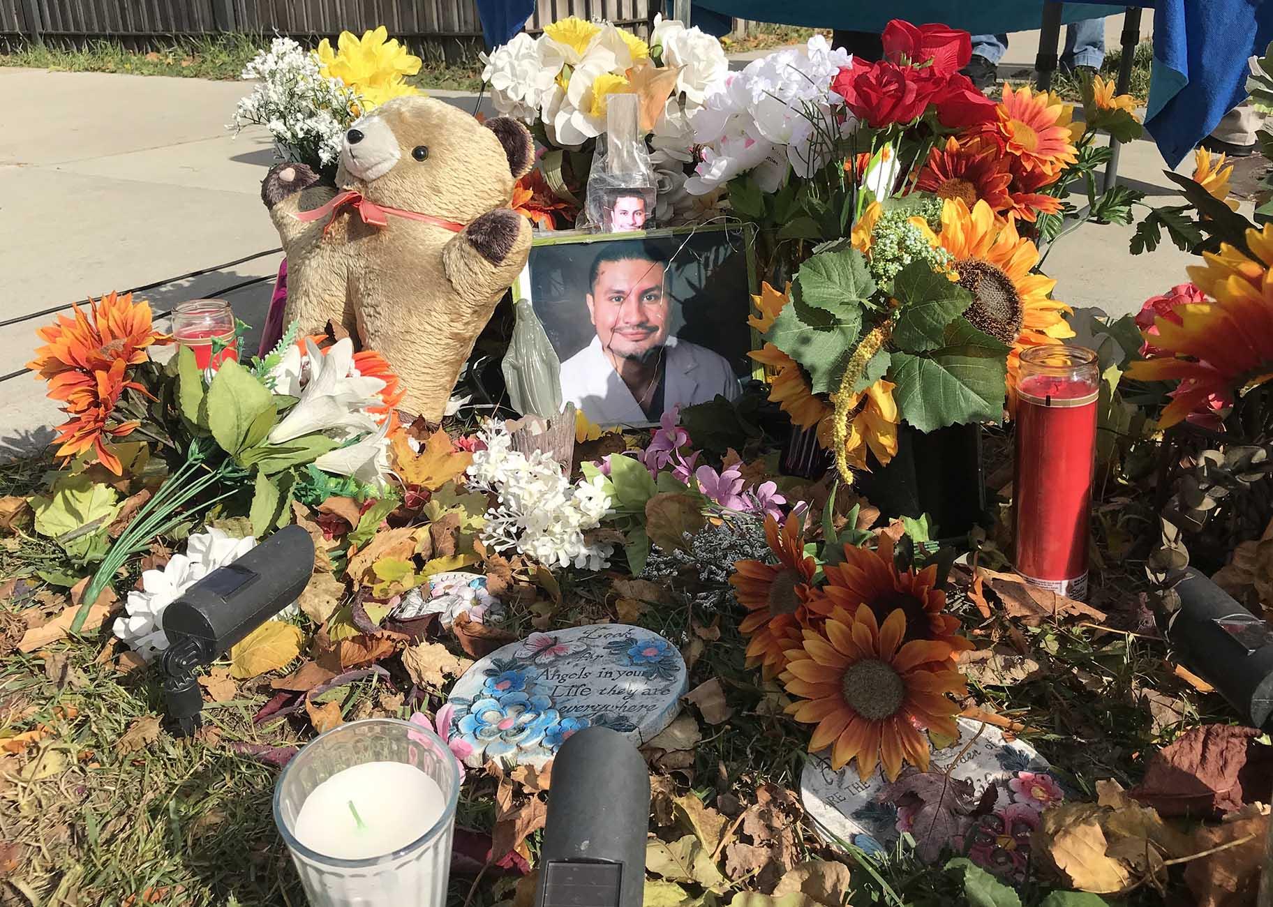 The family of Frank Aguilar added new flowers and a new photo to his memorial at the corner of South Hamlin and West 32nd Street to honor his life on Sunday, Nov. 1, 2020, the eve of Day of the Dead. (Ariel Parrella-Aureli / WTTW News)