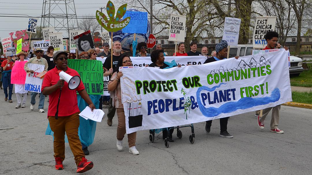 Community Strategy Group organizer April Friendly, left, leads a rally Wednesday during EPA head Scott Pruitt's visit to East Chicago. (Photos by Alex Ruppenthal / Chicago Tonight)