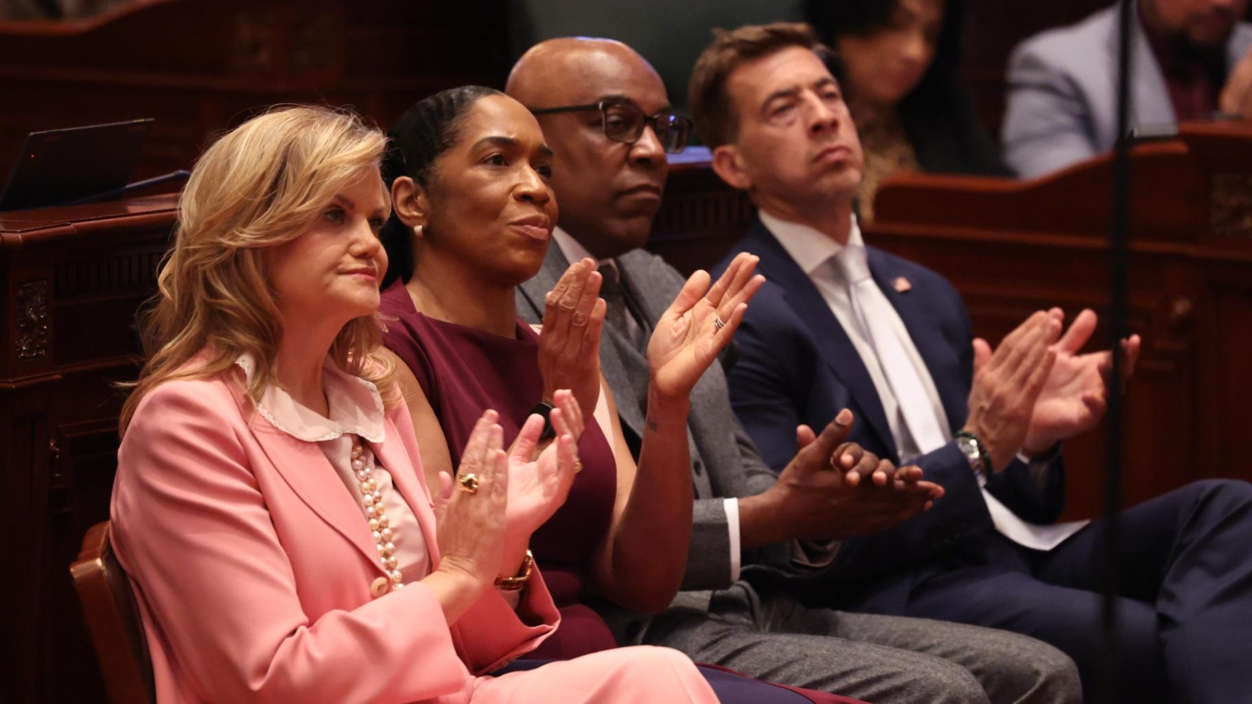 Illinois first lady MK Pritzker, from left, Lt. Gov. Juliana Stratton, Illinois Attorney Genera Kwame Raoul and Secretary of State Alexi Giannoulias listen to Gov. JB Pritzker deliver his annual State of the State and budget address on Feb. 18, 2026, at the Illinois State Capitol in Springfield. (Brian Cassella/Chicago Tribune via Pool)