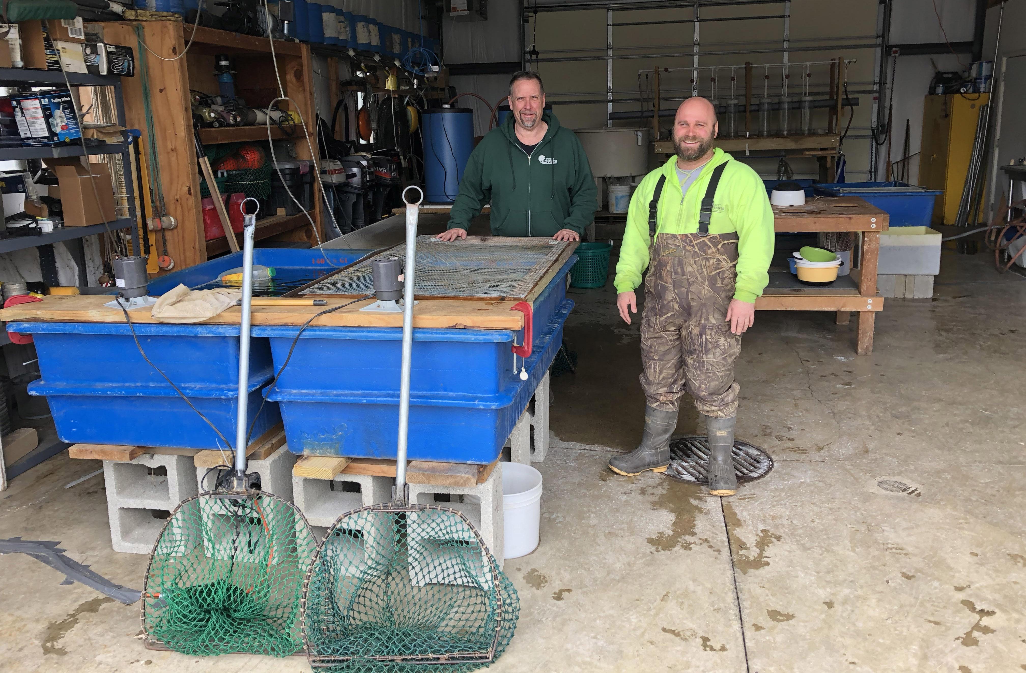 Cook County Fisheries biologists Jim Phillips and Steve Silic in the walleye hatchery.