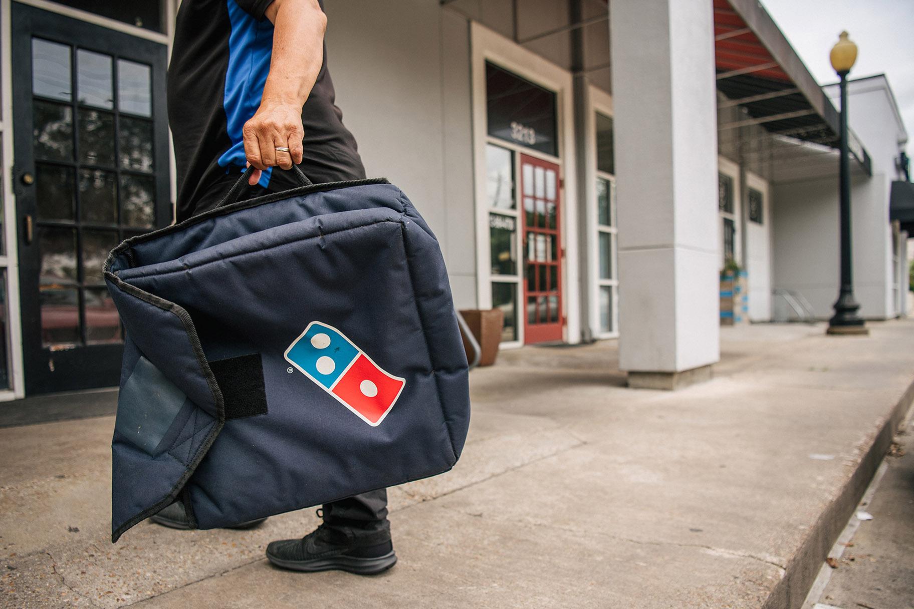 Domino’s Pizza is taking on delivery apps that charge extra fees with a new giveaway totaling $50 million worth of free food. (Brandon Bell / Getty Images)