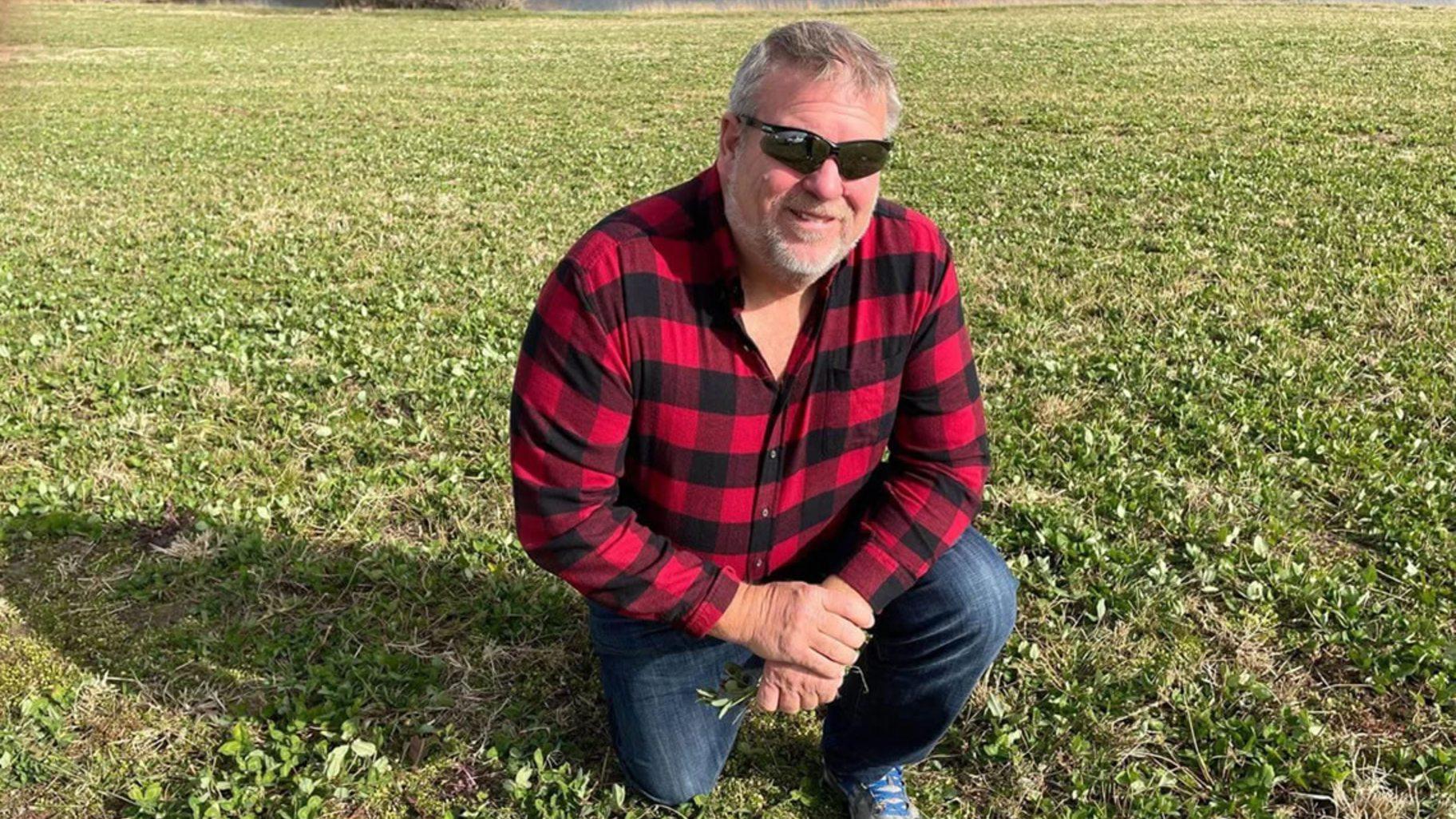State Rep. Charlie Meier, R-Okawville, shows clover growing in a field on his Washington County farm in 2022. In 2009, Meier was awarded the State of Illinois Conservation Farm Family of the Year. (Beth Hundsdorfer / Capitol News Illinois) 