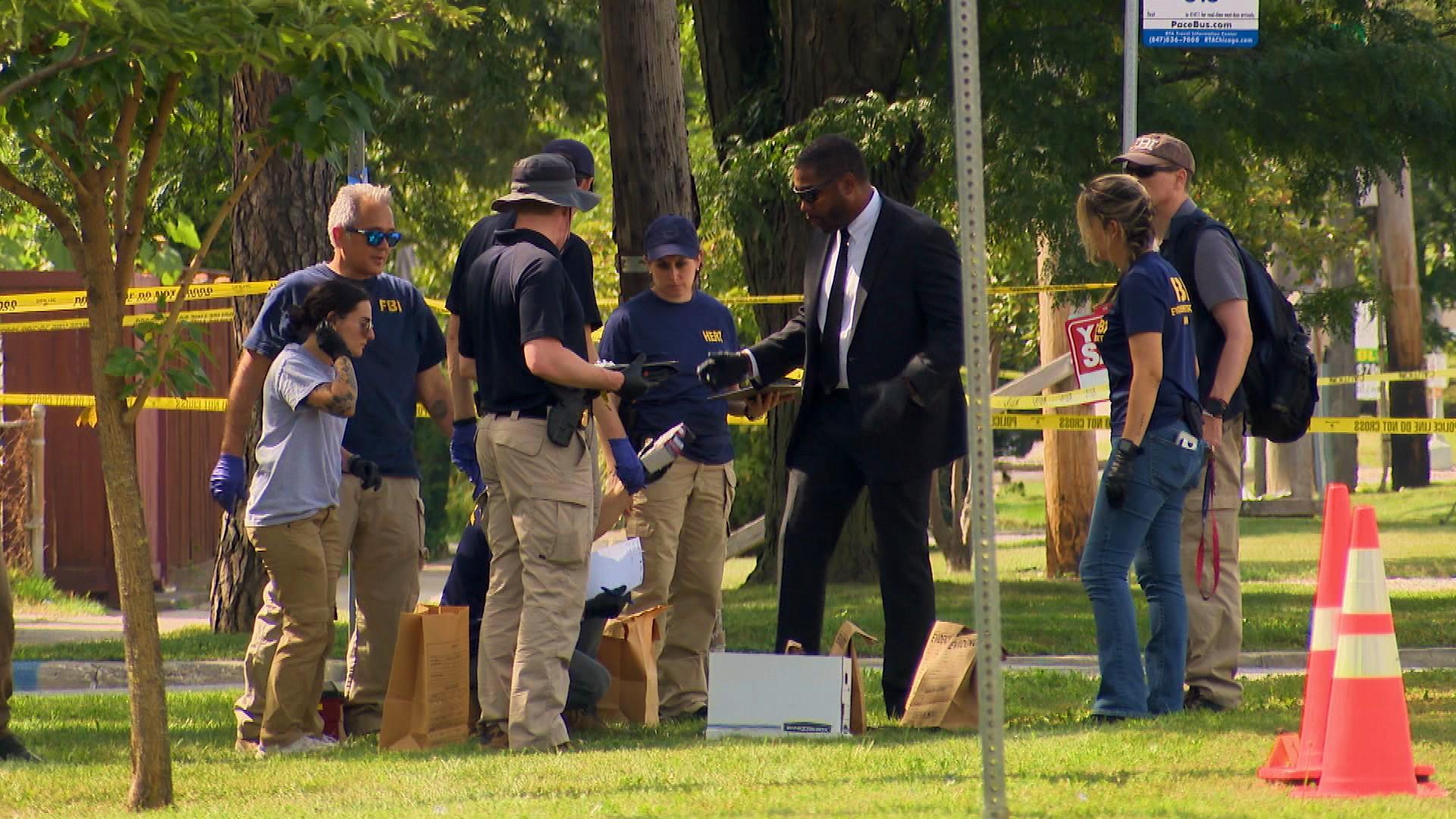 FBI investigators on the scene of a fatal ICE shooting in Frankin Park on Sept. 12, 2025. (WTTW News)