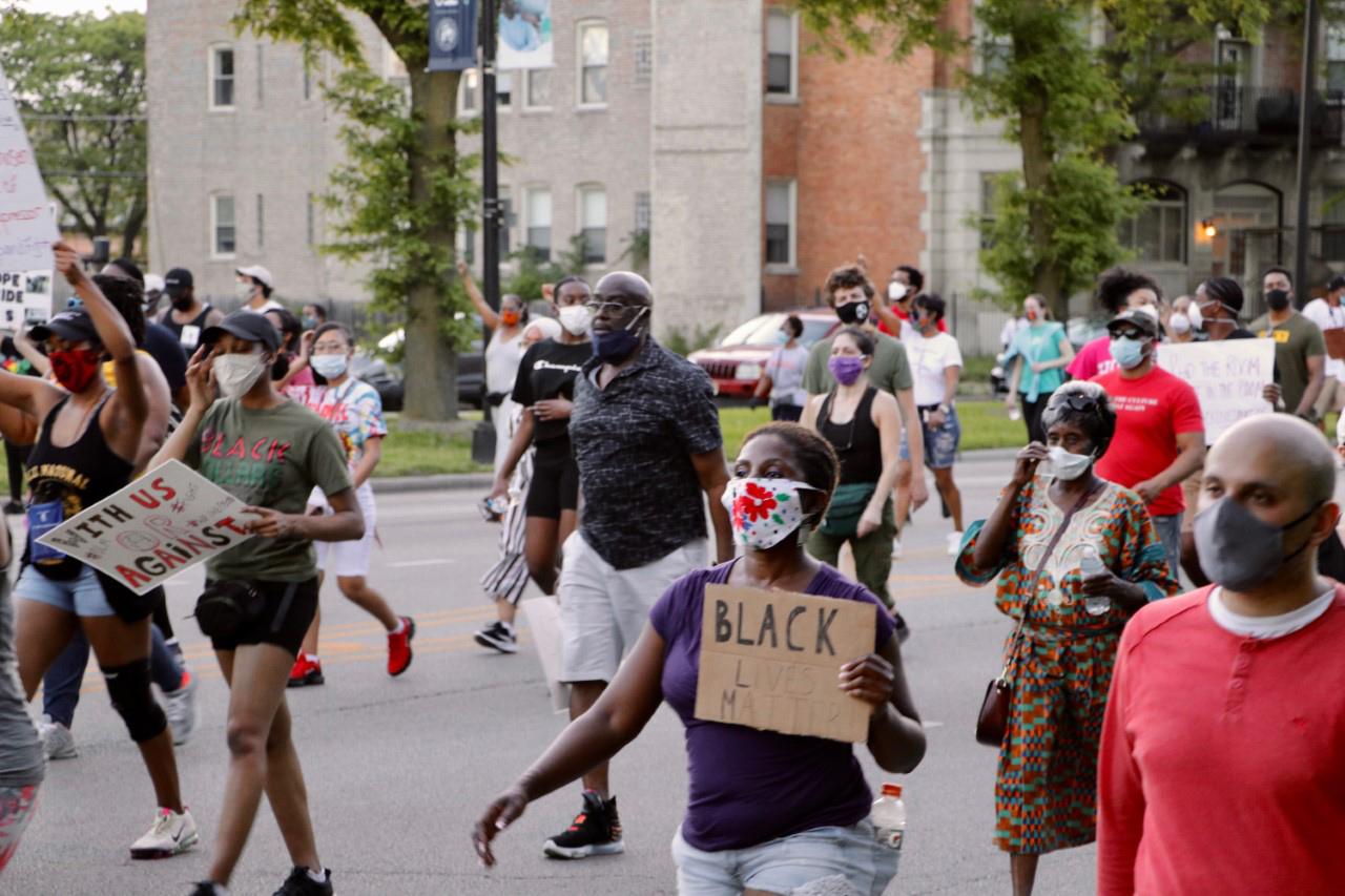 Protesters march down Martin Luther King Jr. Drive in Bronzeville during an evening protest on June 2, 2020 organized by local faith leaders. (Evan Garcia / WTTW News)
