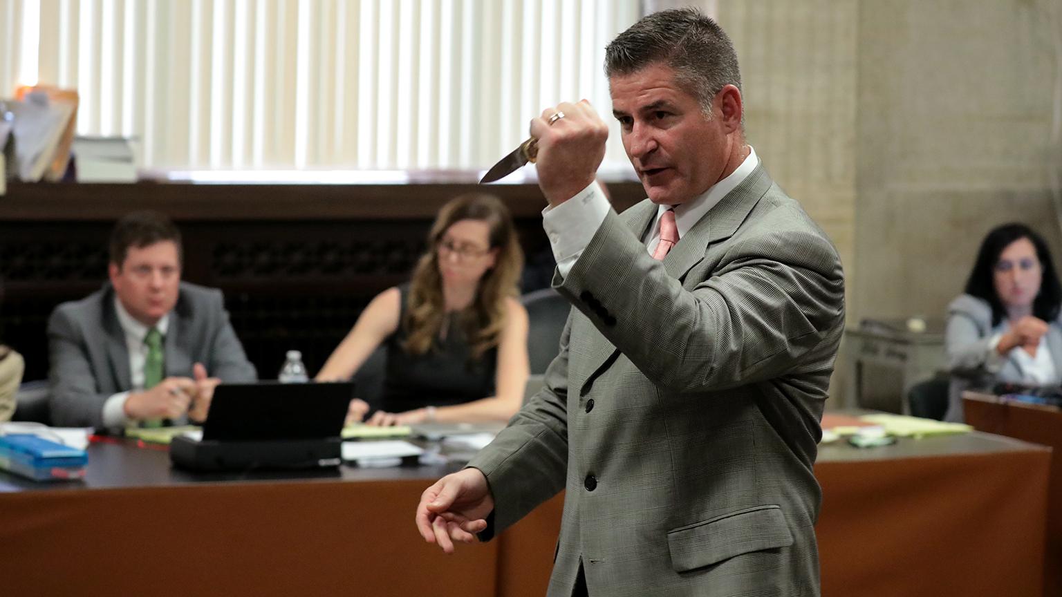 Jason Van Dyke’s lead defense attorney Daniel Herbert gestures with Laquan McDonald’s knife during the fourth day of the trial on Thursday, Sept. 20, 2018. (Antonio Perez / Chicago Tribune / Pool)