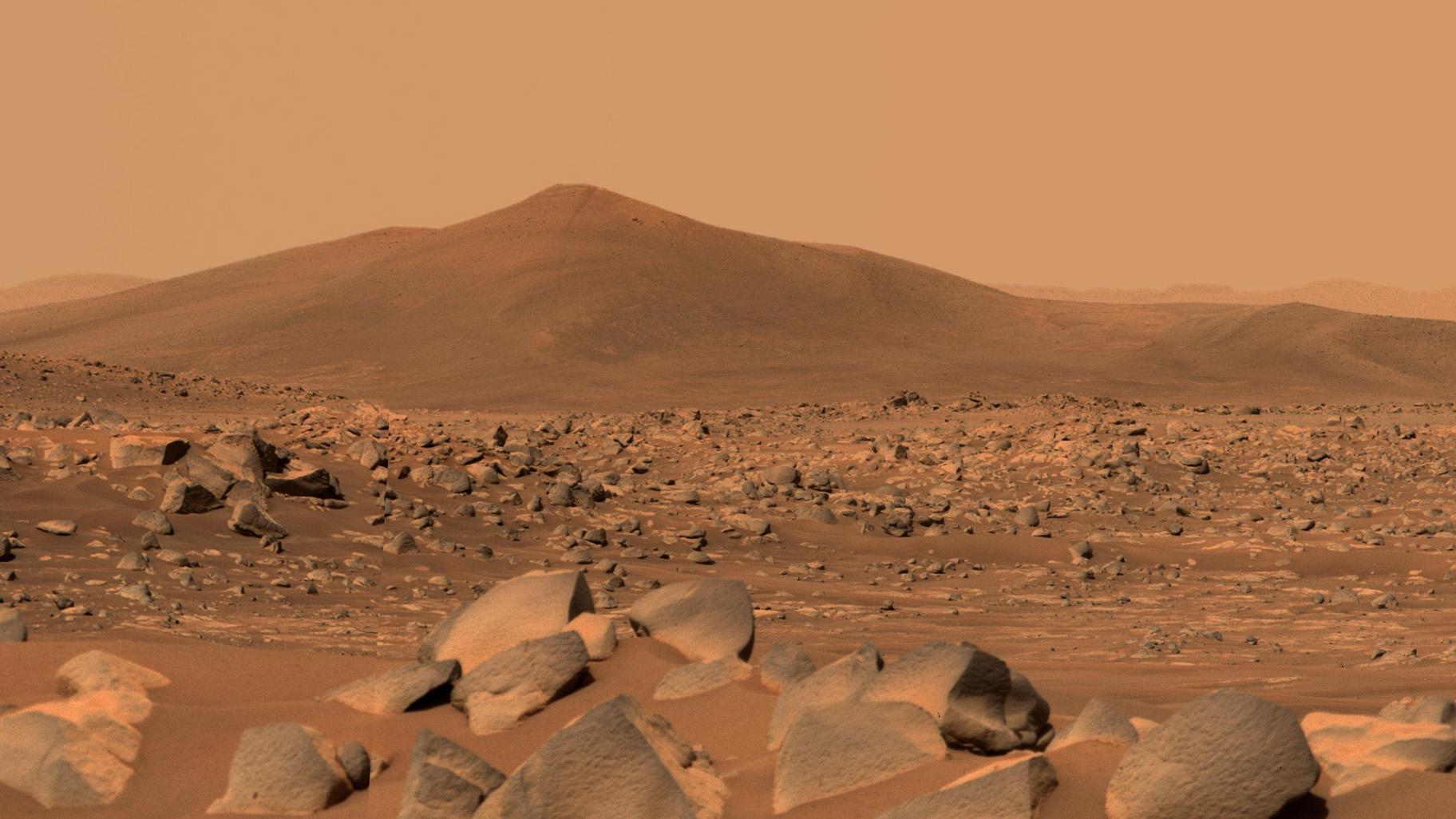 NASA’s Perseverance Mars rover used its dual-camera Mastcam-Z imager to capture this image of “Santa Cruz,” a hill about 1.5 miles away from the rover, on April 29, 2021, the 68th Martian day, or sol, of the mission. The entire scene is inside of Mars’ Jezero Crater; the crater’s rim can be seen on the horizon line beyond the hill. (Credit: NASA / JPL-Caltech / ASU / MSSS)