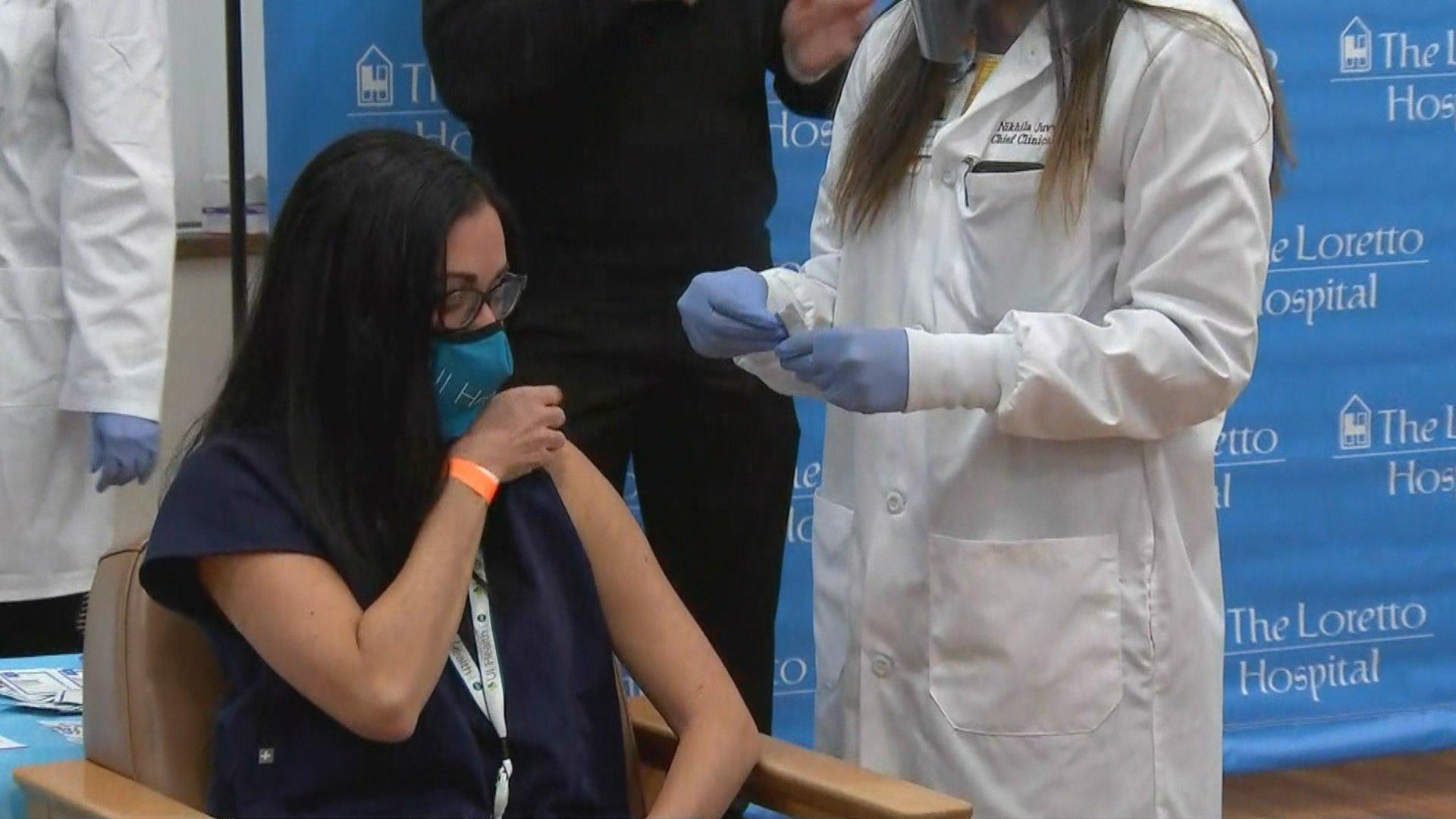 Dr. Marina Del Rios receives the first dose of the COVID-19 vaccine by city officials on Tuesday, Dec. 15, 2020 at The Loretto Hospital. (WTTW News)