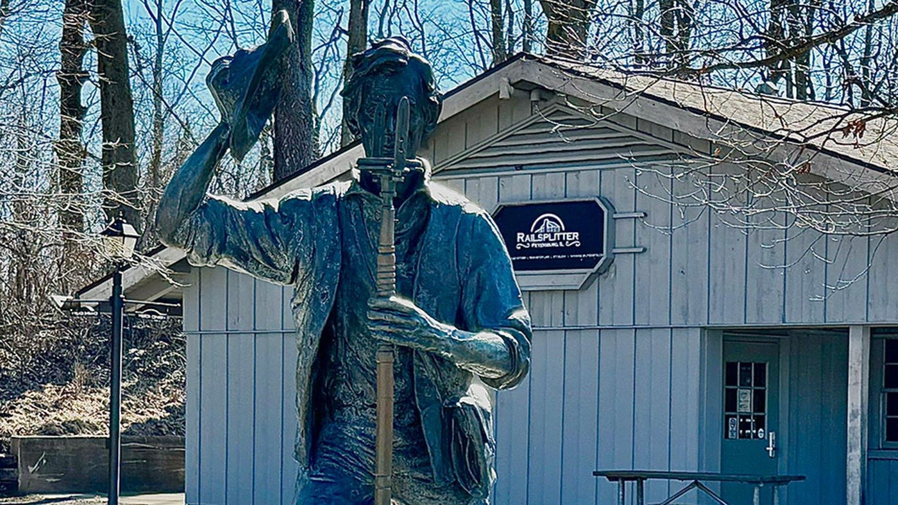 A statue of young Abraham Lincoln stands outside the gift shop and concessions building at the New Salem Historic Site in Petersburg. (Athan Yanos / Medill Illinois News Bureau) A statue of young Abraham Lincoln stands outside the gift shop and concessions building at the New Salem Historic Site in Petersburg. (Athan Yanos / Medill Illinois News Bureau)
