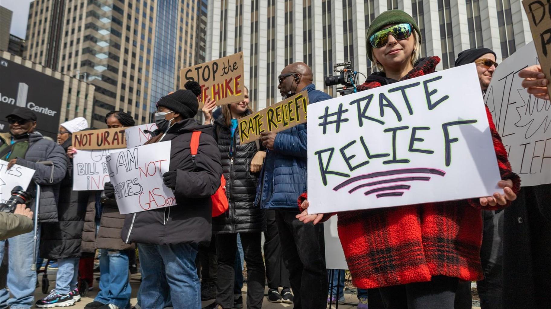Yessenia Balcazar of the Southeast Environmental Task Force holds a sign in downtown Chicago at a March 27, 2023, protest of Peoples Gas’ proposed rate increase. (Andrew Adams / Capitol News Illinois) 