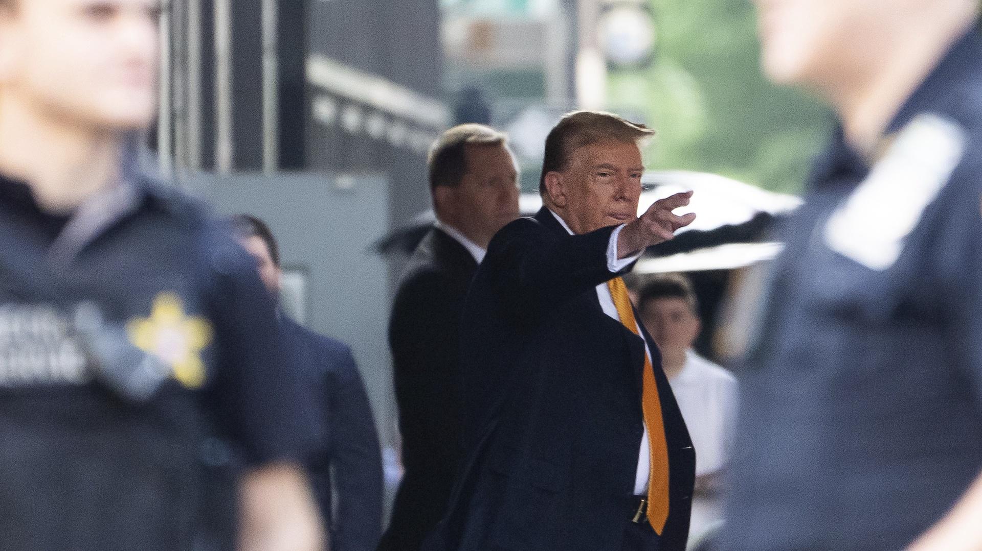 Former president Donald Trump waves while leaving Trump Tower on his way to Manhattan criminal court, Tuesday, May 21, 2024, in New York. (AP Photo/Julia Nikhinson)