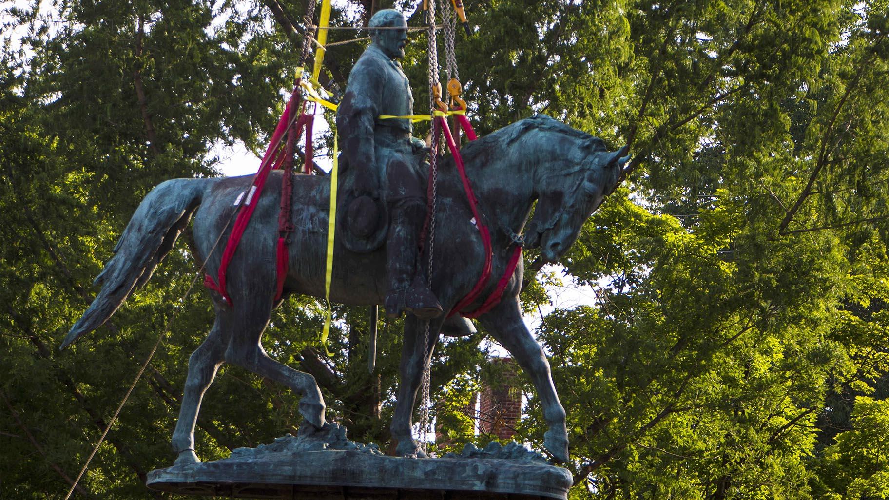 Workers remove the monument of Confederate General Robert E. Lee on Saturday, July 10, 2021 in Charlottesville, Va. The removal of the Lee statue follows years of contention, community anguish and legal fights. (AP Photo / John C. Clark)