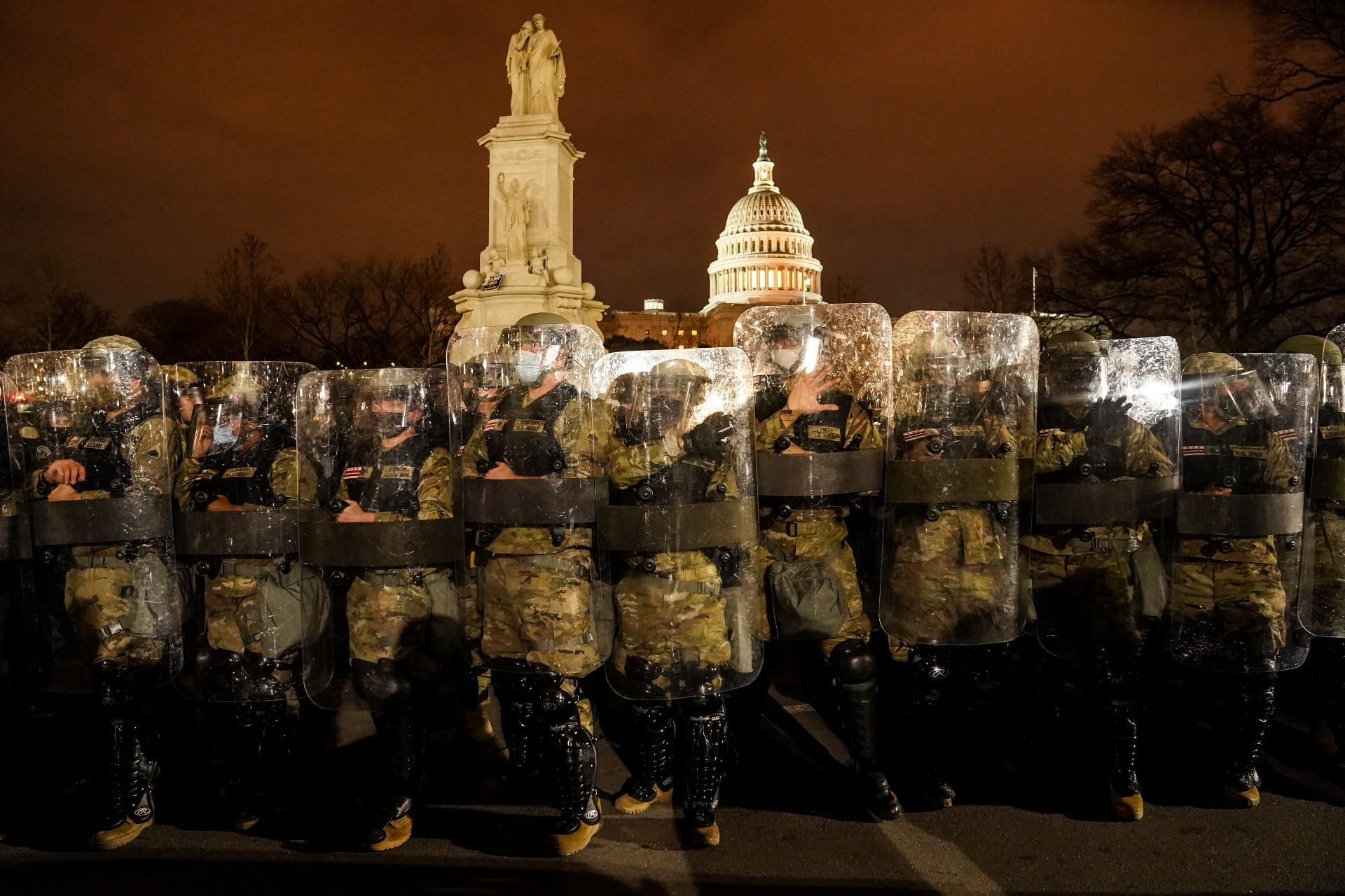 District of Columbia National Guard stand outside the Capitol, Wednesday night, Jan. 6, 2021, after a day of rioting protesters. (AP Photo / John Minchillo)