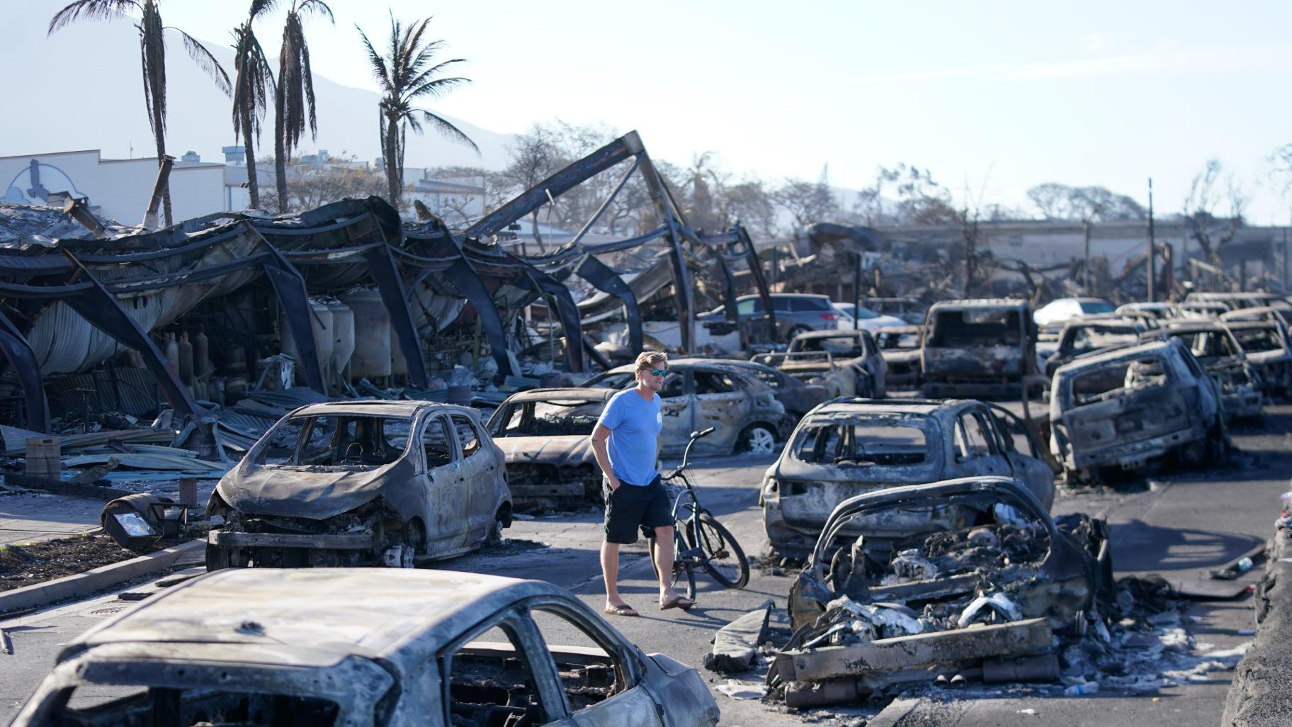 A man walks through wildfire wreckage Friday, Aug. 11, 2023, in Lahaina, Hawaii. (Rick Bowmer / AP Photo)