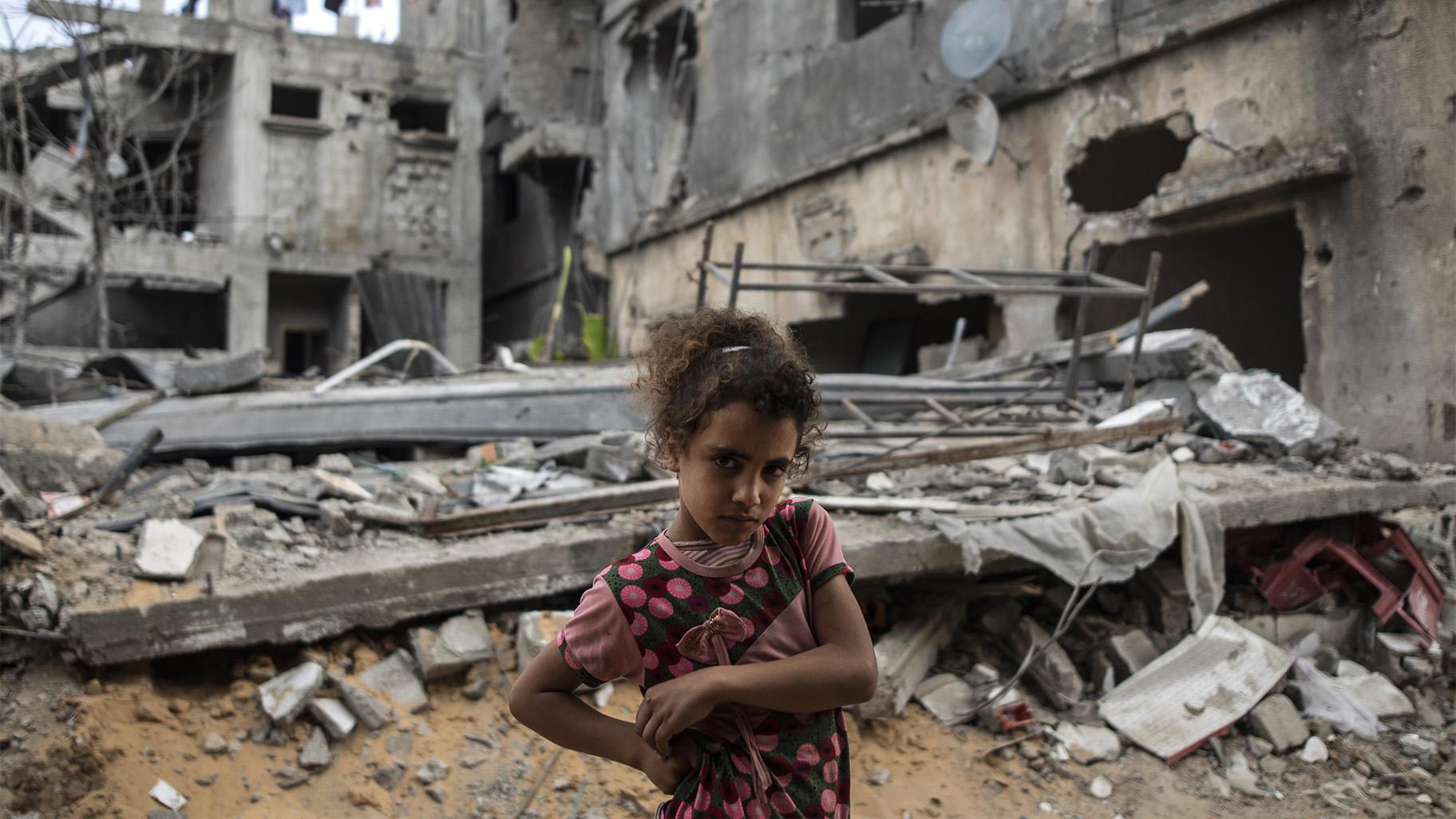 Palestinian Rahaf Nuseir, 10, looks on as she stands in front of her family's destroyed homes, to which they returned following a cease-fire reached after an 11-day war between Gaza's Hamas rulers and Israel, in town of Beit Hanoun, northern Gaza Strip, Friday, May 21, 2021. (AP Photo / Khalil Hamra)