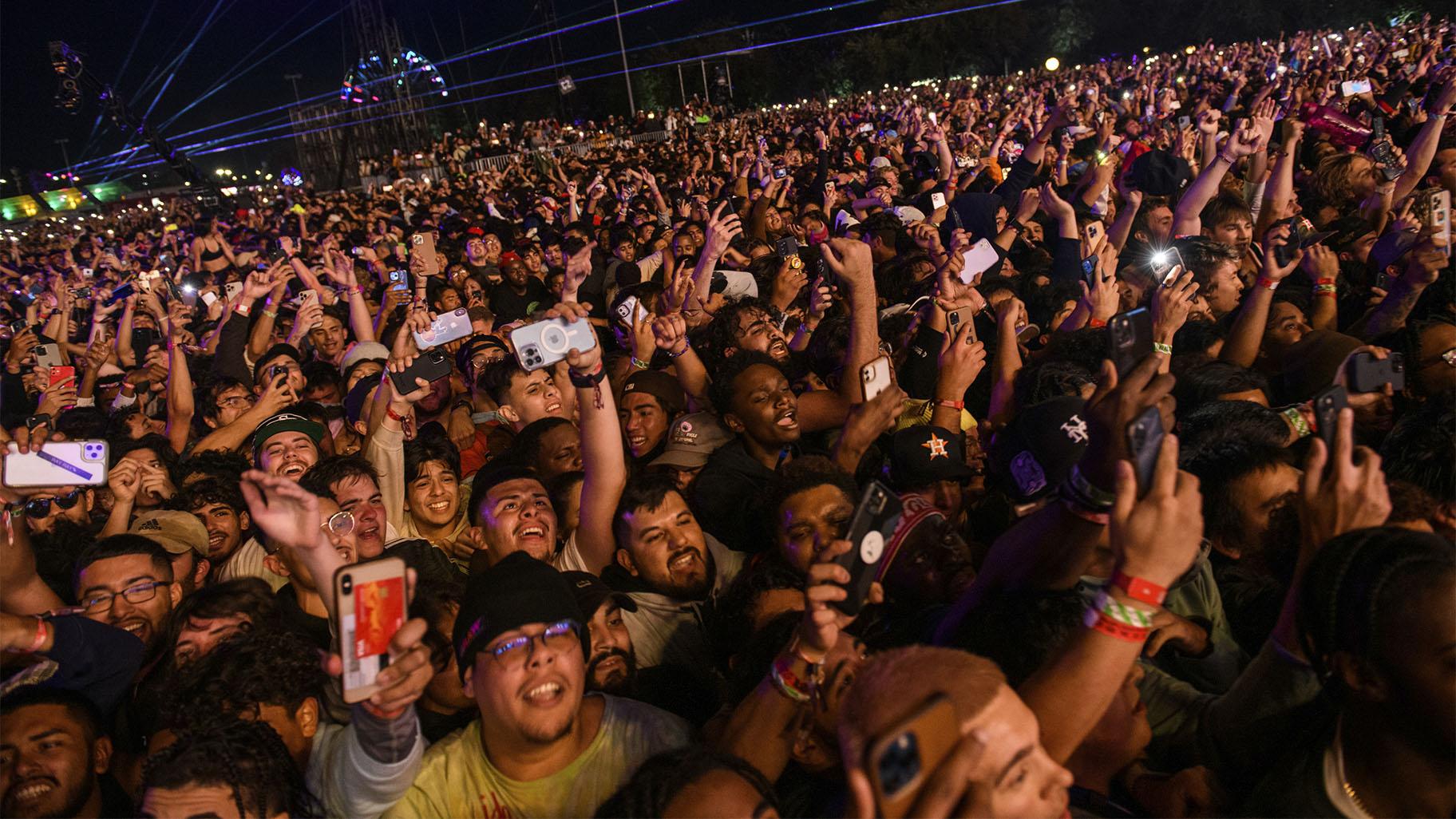 The crowd watches as Travis Scott performs at Astroworld Festival at NRG park on Friday, Nov. 5, 2021 in Houston.  (Jamaal Ellis / Houston Chronicle via AP)