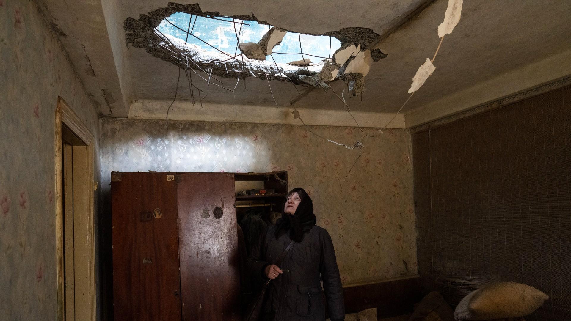 Halyna Falko looks at the destruction caused after a Russian attack inside her house near Brovary, on the outskirts of Kyiv, Ukraine, Monday, March 28, 2022. (AP Photo / Rodrigo Abd)