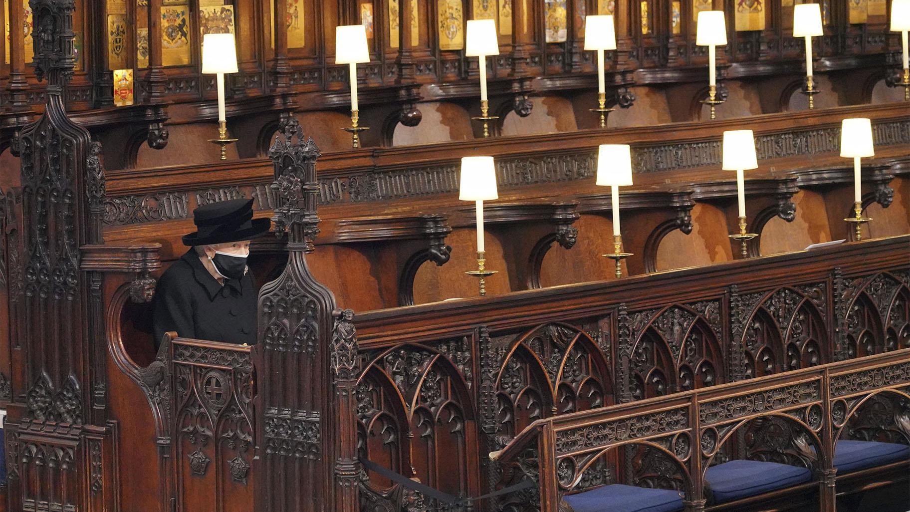 Britain's Queen Elizabeth II sits alone in St. George’s Chapel during the funeral of Prince Philip, the man who had been by her side for 73 years, at Windsor Castle, Windsor, England, Saturday April 17, 2021. Prince Philip died April 9 at the age of 99 after 73 years of marriage to Britain's Queen Elizabeth II. (Jonathan Brady / Pool via AP)