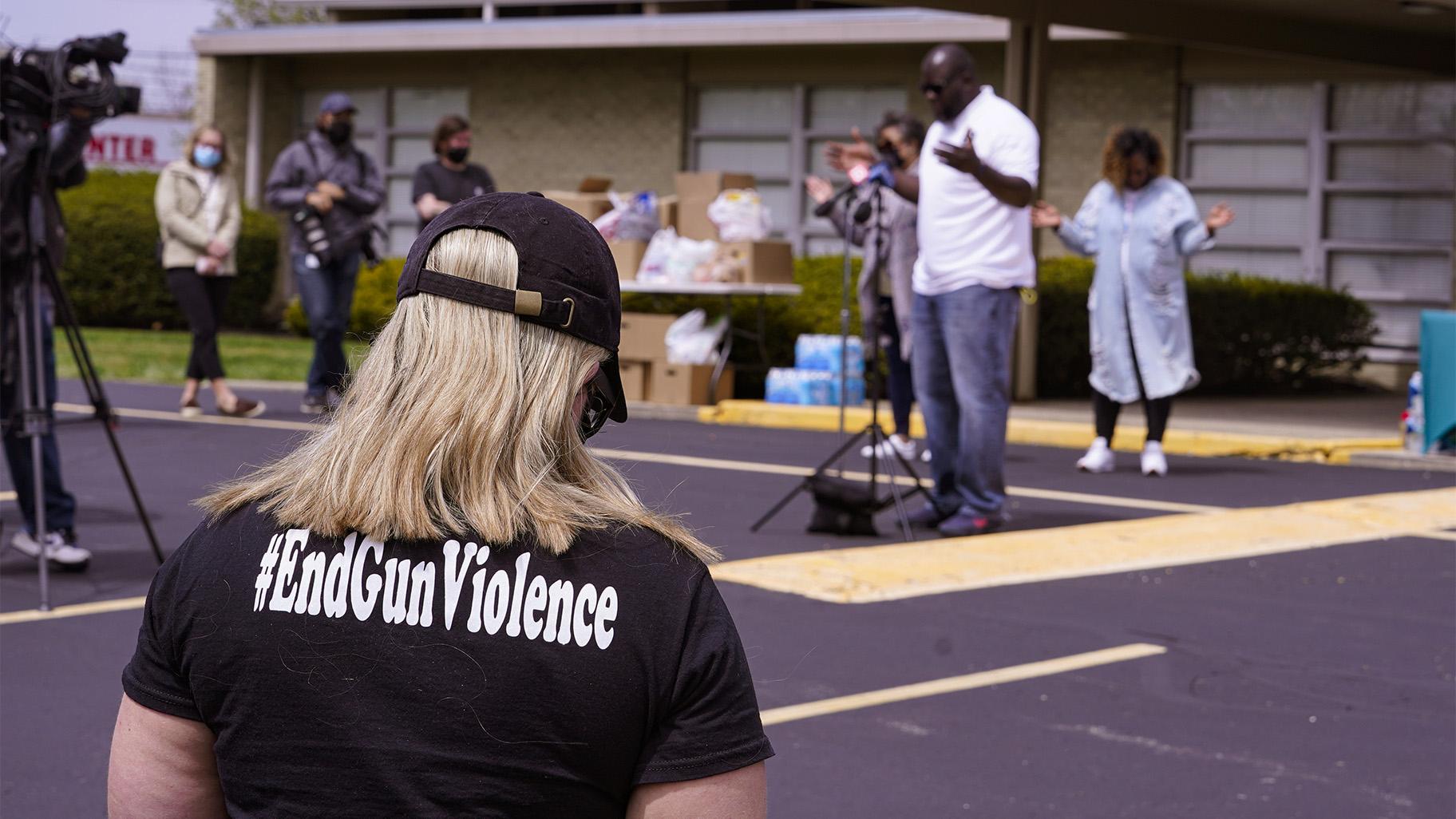A woman wears a shirt calling for the end of gun violence during a vigil at the Olivet Missionary Baptist Church for the victims of the shooting at a FedEx facility in Indianapolis, Saturday, April 17, 2021. A gunman killed eight people and wounded several others before taking his own life in a late-night attack at a FedEx facility near the Indianapolis airport, police said. (AP Photo / Michael Conroy)
