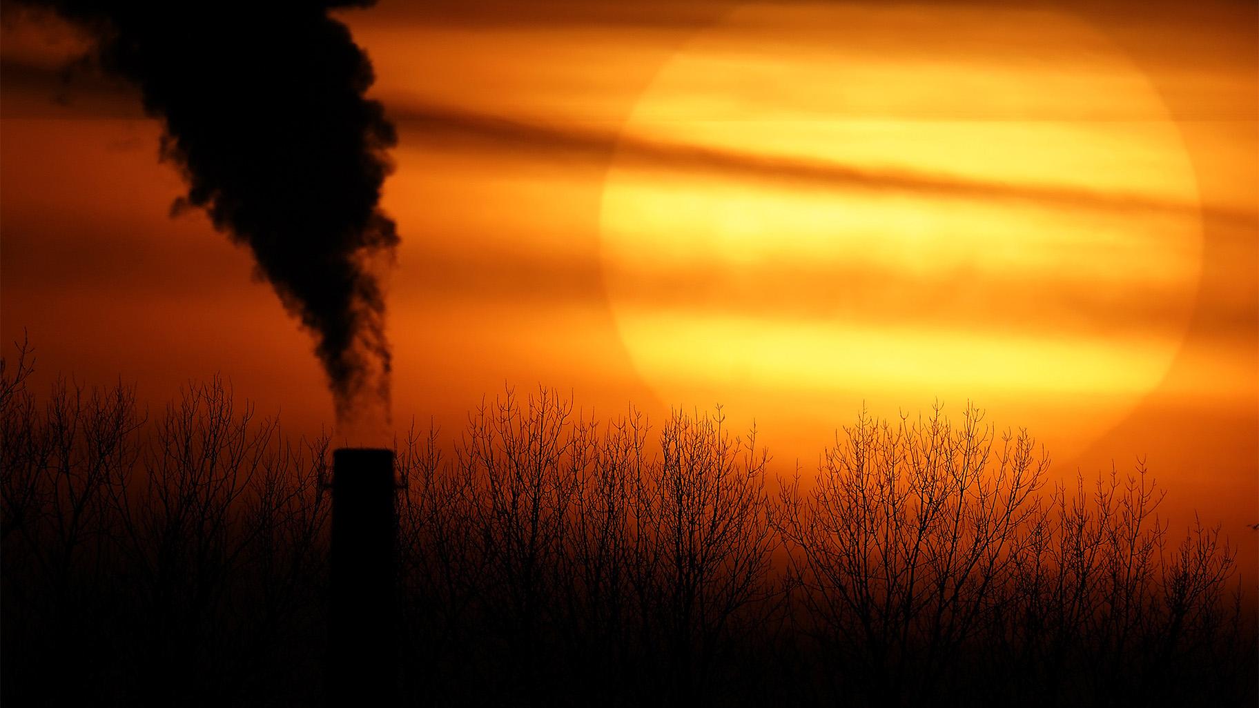 In this Feb. 1, 2021 file photo, emissions from a coal-fired power plant are silhouetted against the setting sun in Independence, Mo. (AP Photo / Charlie Riedel, File)