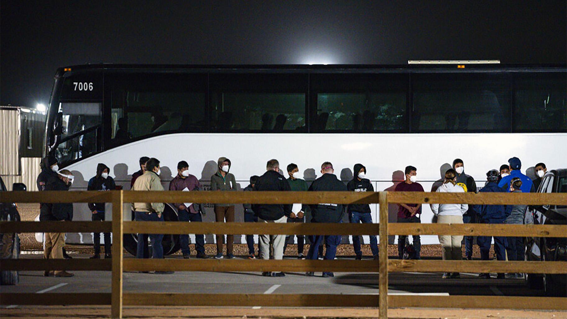 The Biden administration is not requiring FBI fingerprint background checks of caregivers at its rapidly expanding network of emergency sites to hold thousands of immigrant teenagers. In this Sunday, March 14, 2021, file photo, migrant children and teenagers are processed after entering the site of a temporary holding facility south of Midland, Texas. (Eli Hartman / Odessa American via AP, File)