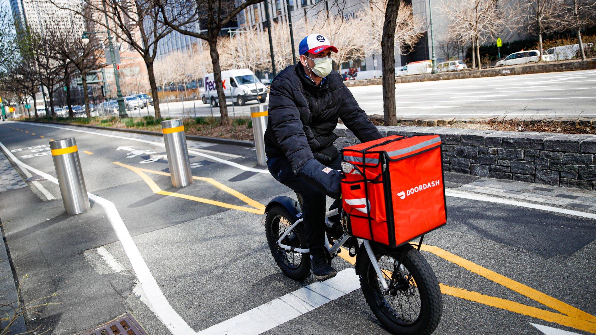 In this March 16, 2020 file photo, a delivery worker rides his bicycle along a path on the West Side Highway in New York. (AP Photo / John Minchillo, File)