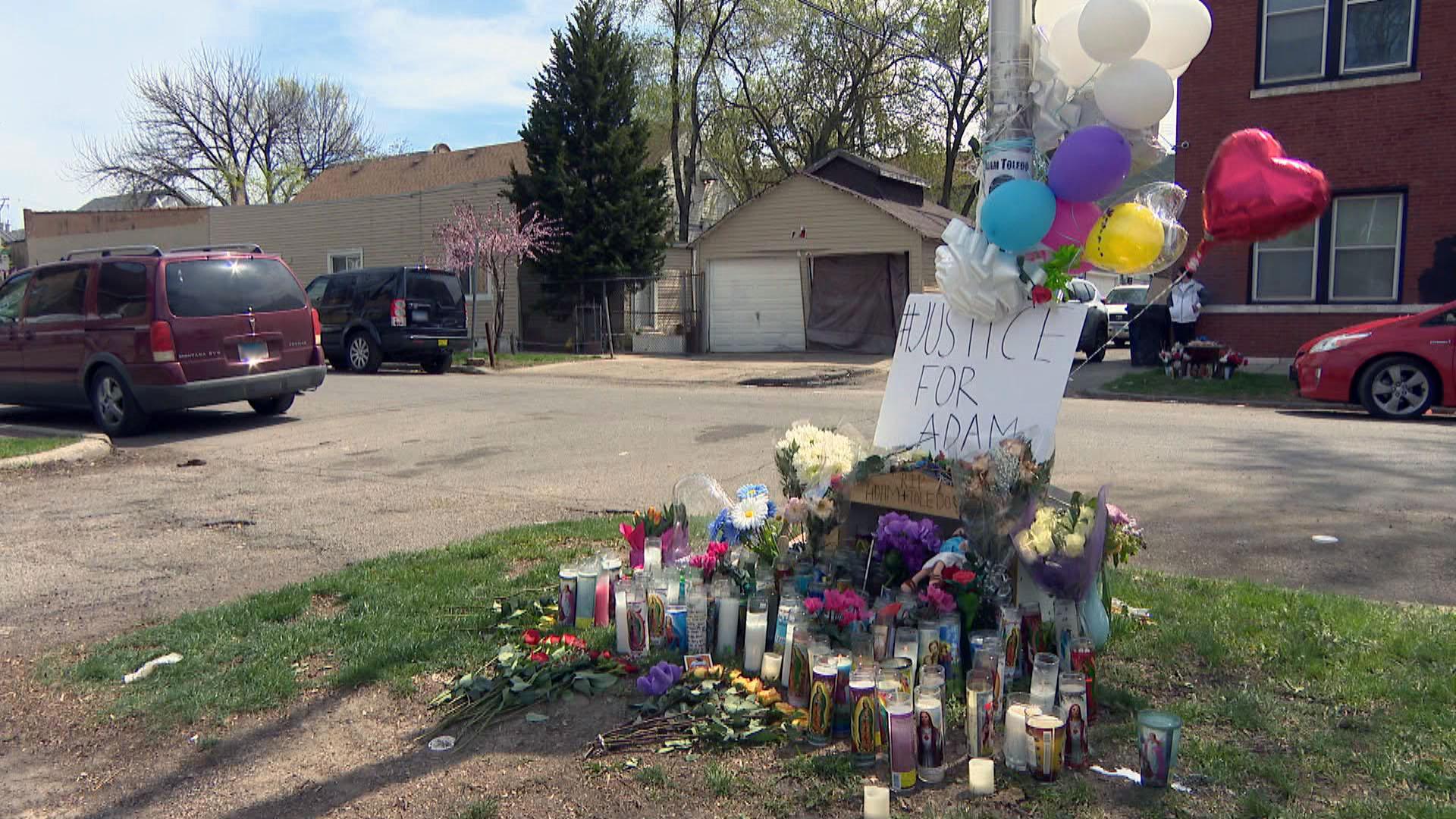 A memorial of candles and flowers for 13-year-old Adam Toledo sits near the alley where he was killed March 29 by a Chicago police officer. (WTTW News)
