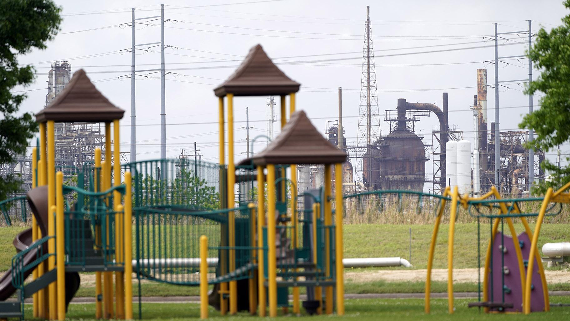 In this Monday, March 23, 2020 file photo, a playground outside the Prince Hall Village Apartments sits empty near one of the petrochemical facilities in Port Arthur, Texas. (AP Photo / David J. Phillip)