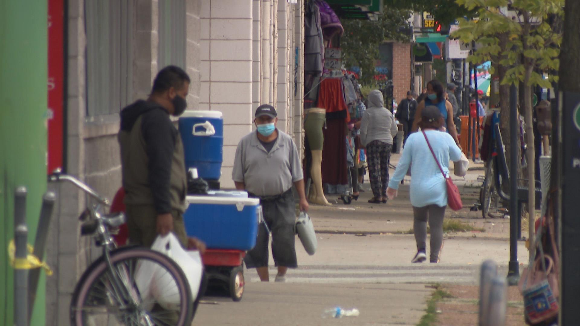 People wearing face masks walk in Chicago’s Albany Park neighborhood on Friday, Sept. 18, 2020, where a spate of recent shootings have added to concerns about public safety. (WTTW News)