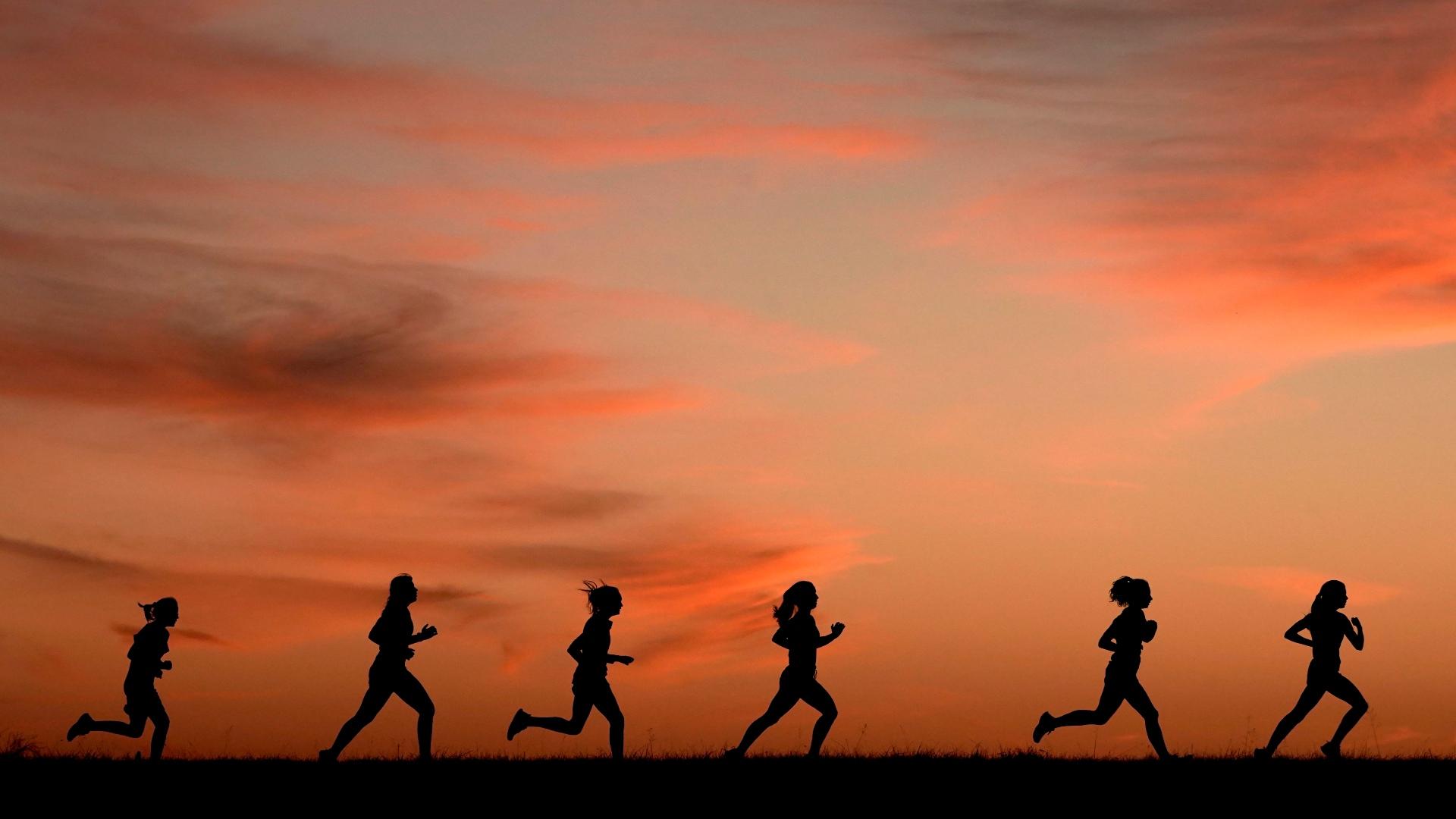 High school students run at sunset as they practice for the track and field season Monday, Feb. 28, 2022, in Shawnee, Kan. (AP Photo / Charlie Riedel, File)