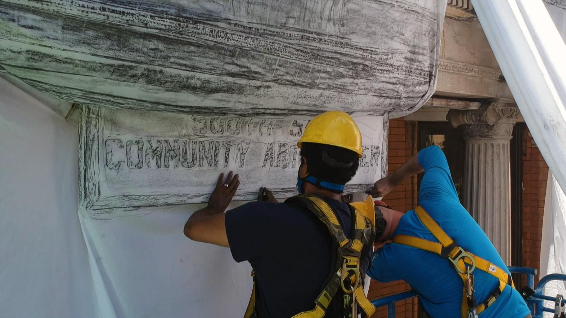Artist Faheem Majeed and students spent six days in August 2020 laying sheets across the South Side Art Center to make a graphite rubbing of the building. (Courtesy Steven Rosofsky / Moving Pictures)