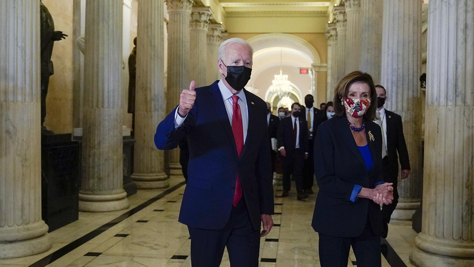 President Joe Biden gives a thumbs up as he walks with House Speaker Nancy Pelosi of Calif., on Capitol Hill in Washington, Friday, Oct. 1, 2021, after attending a meeting with the House Democratic caucus to try to resolve an impasse around the bipartisan infrastructure bill. (AP Photo / Susan Walsh)