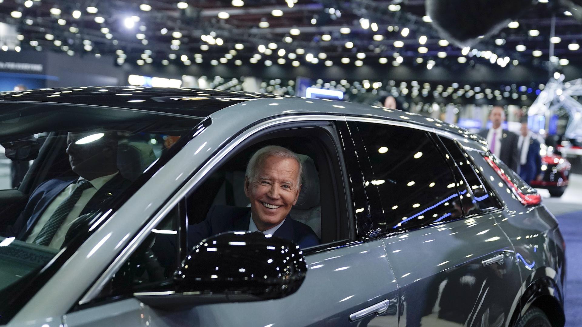 President Joe Biden drives a Cadillac Lyriq through the showroom during a tour at the Detroit Auto Show, Sept. 14, 2022, in Detroit. Biden persuaded Democrats in Congress to provide hundreds of billions of dollars to fight climate change.  (AP Photo/Evan Vucci, File)