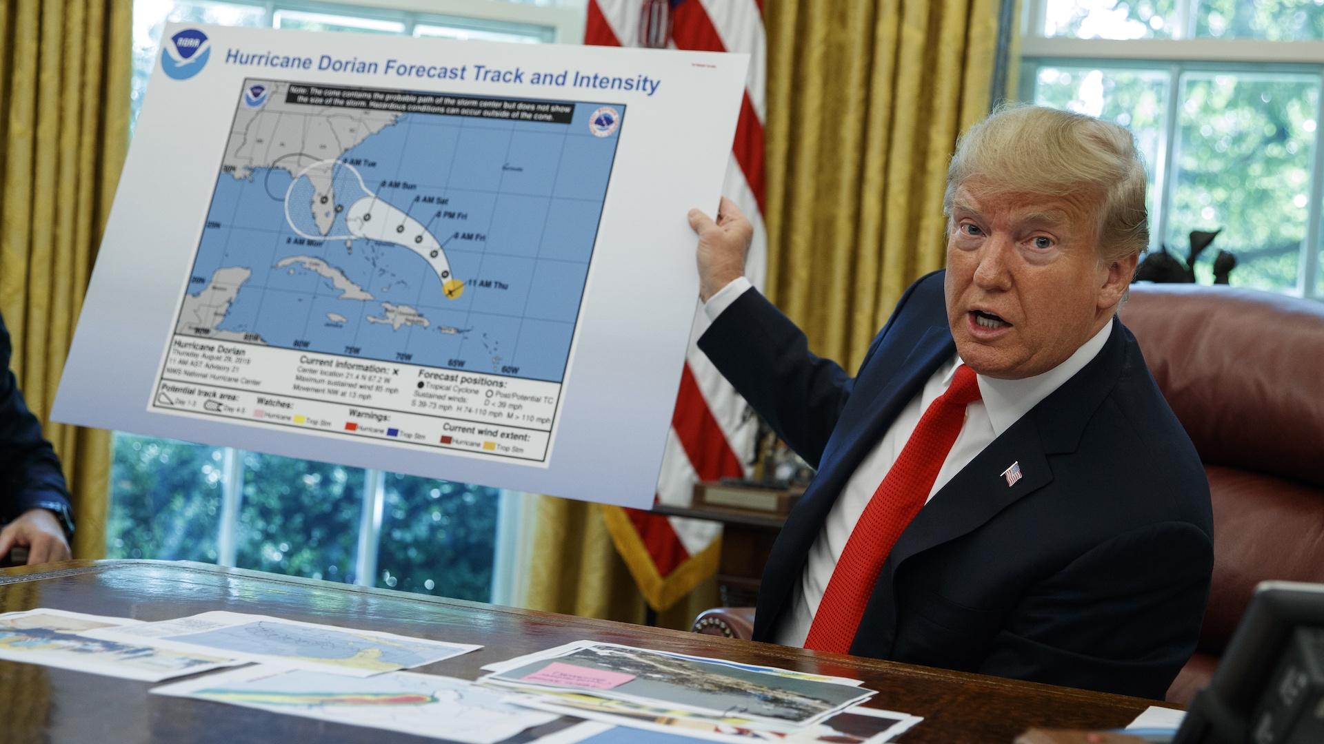 In this Wednesday, Sept. 4, 2019, file photo, President Donald Trump talks with reporters after receiving a briefing on Hurricane Dorian in the Oval Office of the White House, in Washington. (AP Photo/Evan Vucci, File)